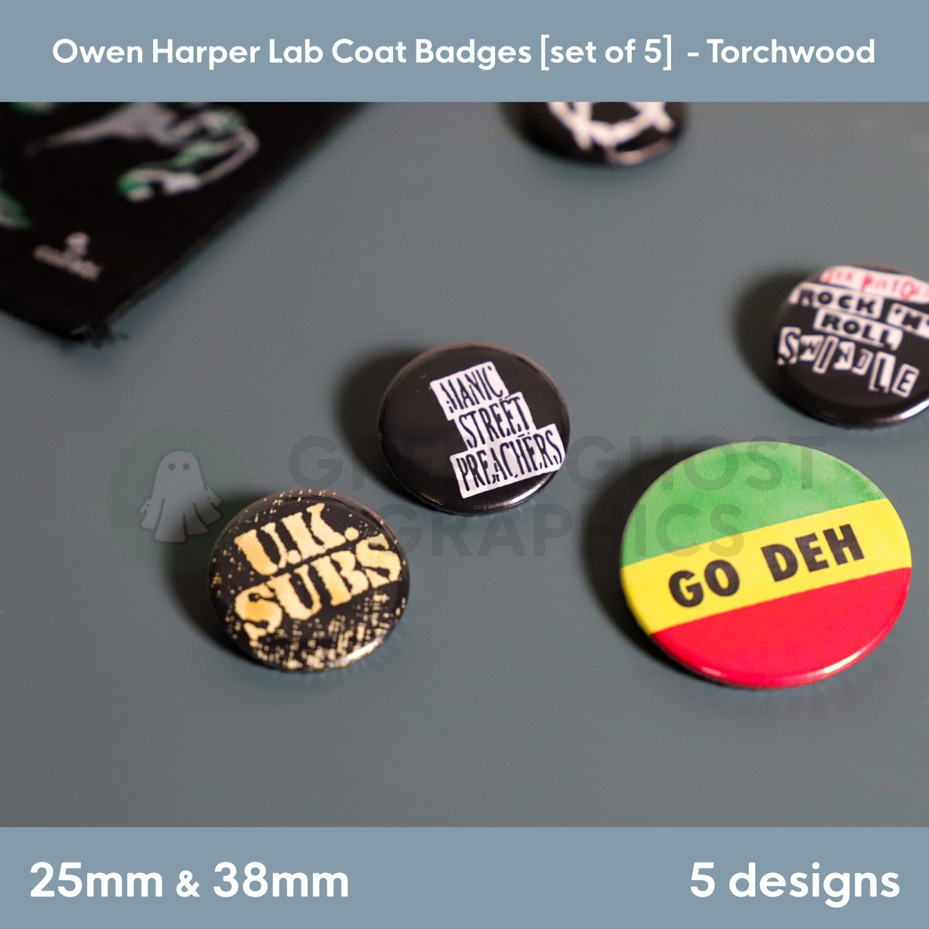 Four round badges featuring the texts “UK SUBS”, “MANIC STREET PREACHERS”, “ROCK ’N’ ROLL SWINDLE”, and “GO DEH” arranged together on a tabletop display.