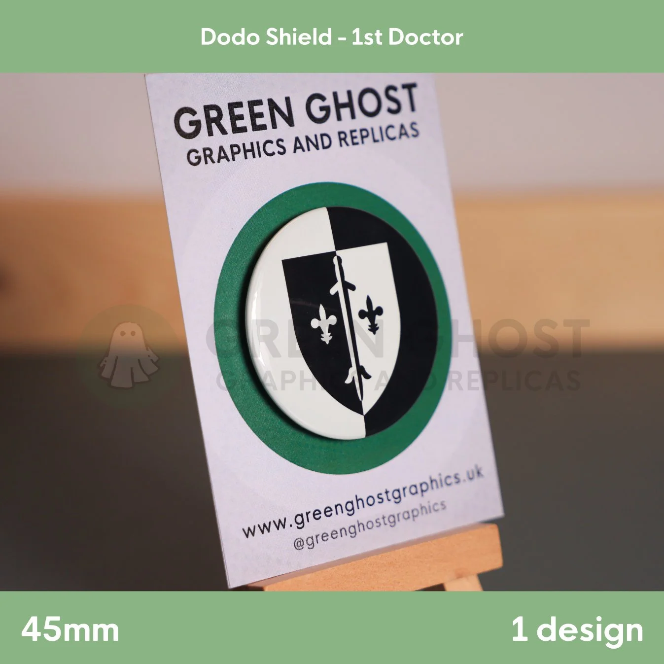 A round badge with a two‑tone shield and central vertical motif mounted on a branded backing card.