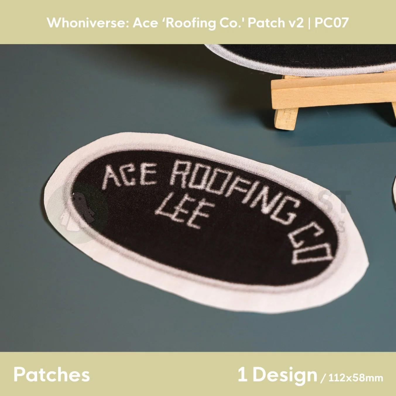 Close up of the uncut unfinished version of the Roofing patch design, on a plain aqua green background.