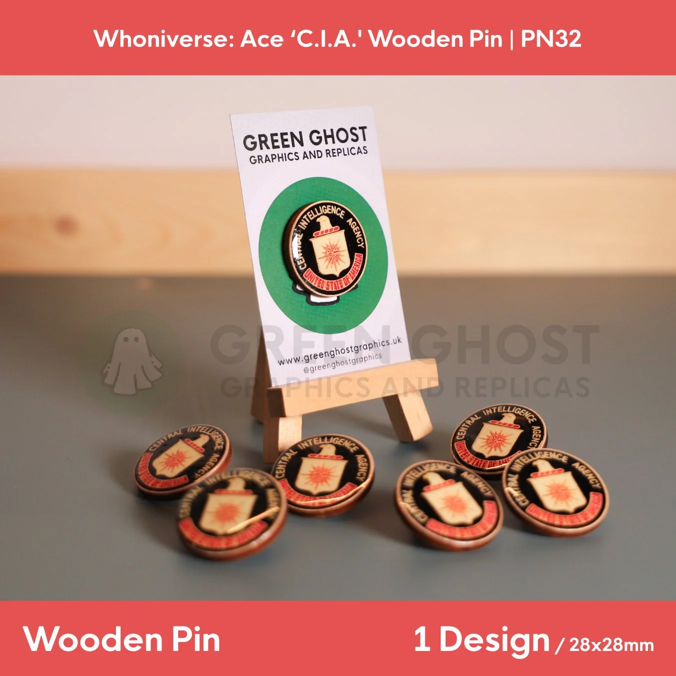 A circular “Central Intelligence Agency, United States of America” wooden pin attached to a branded backing card on a wooden easel, with several identical pins scattered around the base.