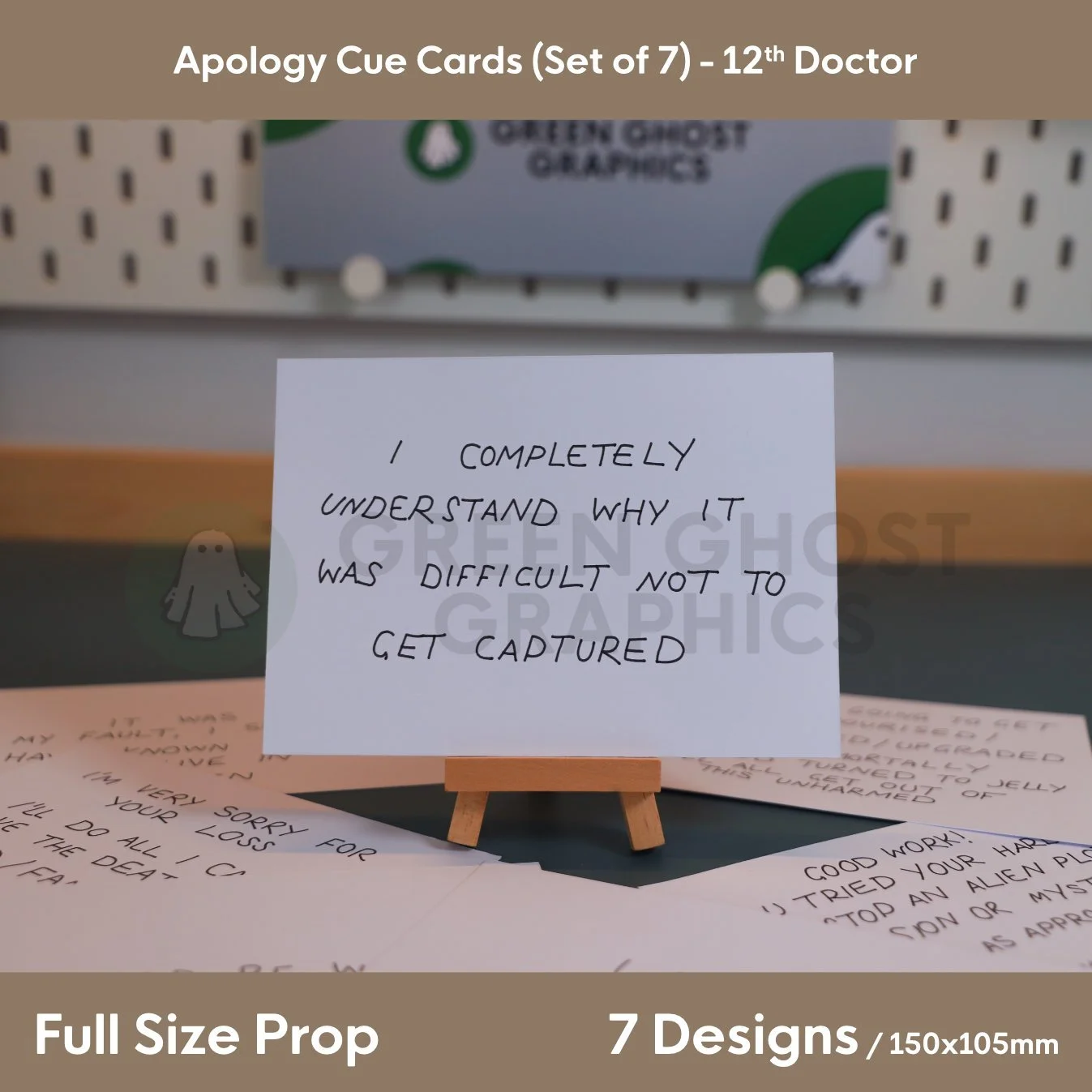 A white rectangular cue card printed with “I COMPLETELY UNDERSTAND WHY IT WAS DIFFICULT NOT TO GET CAPTURED” presented on a miniature easel among a set of apology cards.