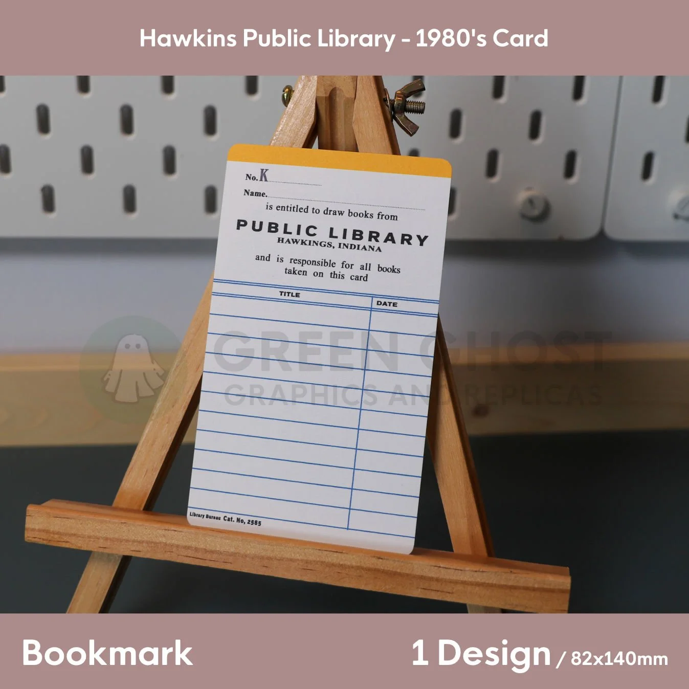 A vintage‑style Hawkins Public Library card displayed on a wooden easel, featuring blank spaces for name, book titles, and dates in an early‑1980s design.
