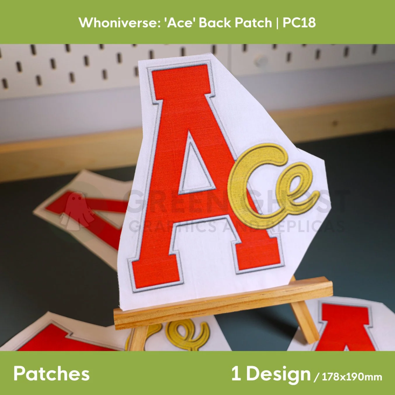 Close up of the Ace patch on an easel on a aqua green background.