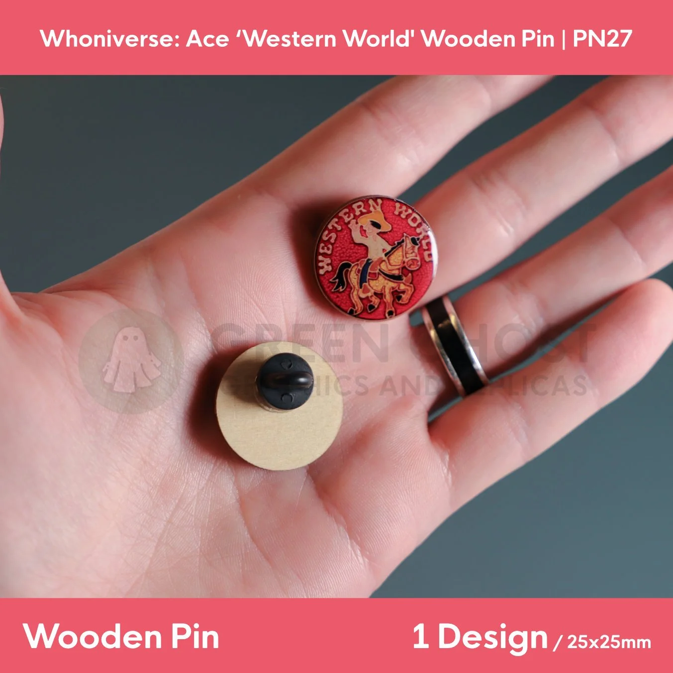 A close‑up of two circular “WESTERN WORLD” wooden pins held in a hand, showing the front horse‑and‑rider design and the back with a clasp attachment.