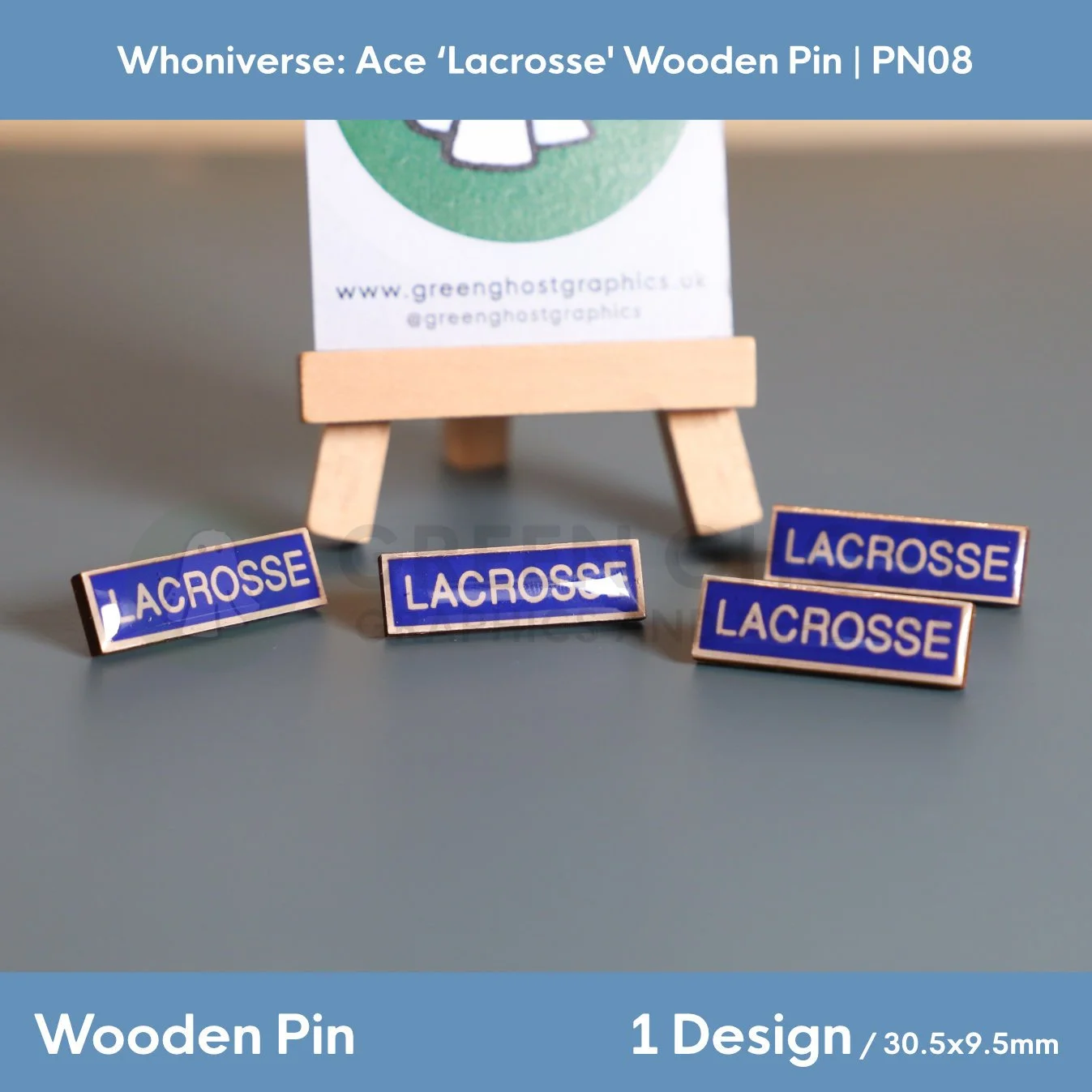 Four rectangular wooden “LACROSSE” pins displayed on a flat surface, with one pin propped against a branded backing card on a wooden easel.