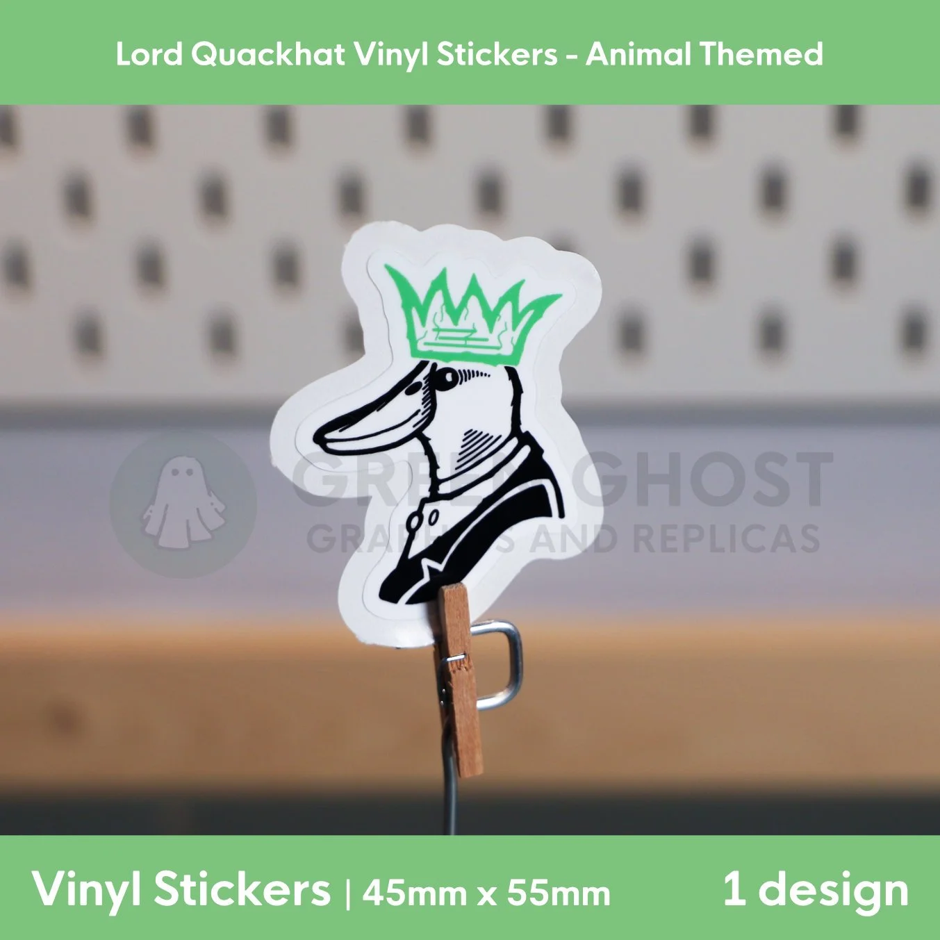 Rough lino printed style sticker of a mallard duck with a green party hat / crown on a blurred peg board background.