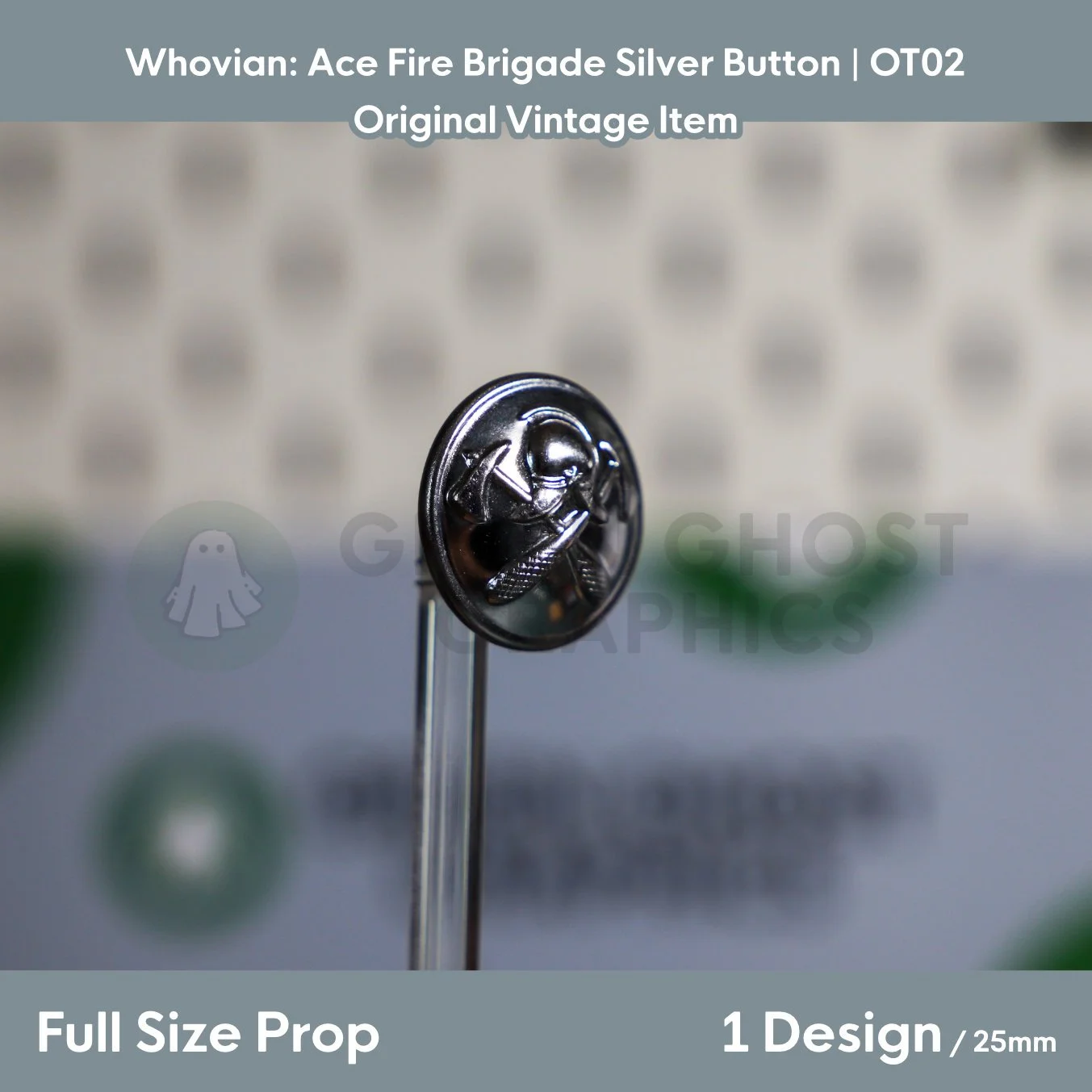 A circular metallic silver button featuring a raised fire brigade emblem shown at an angle on a transparent display rod.