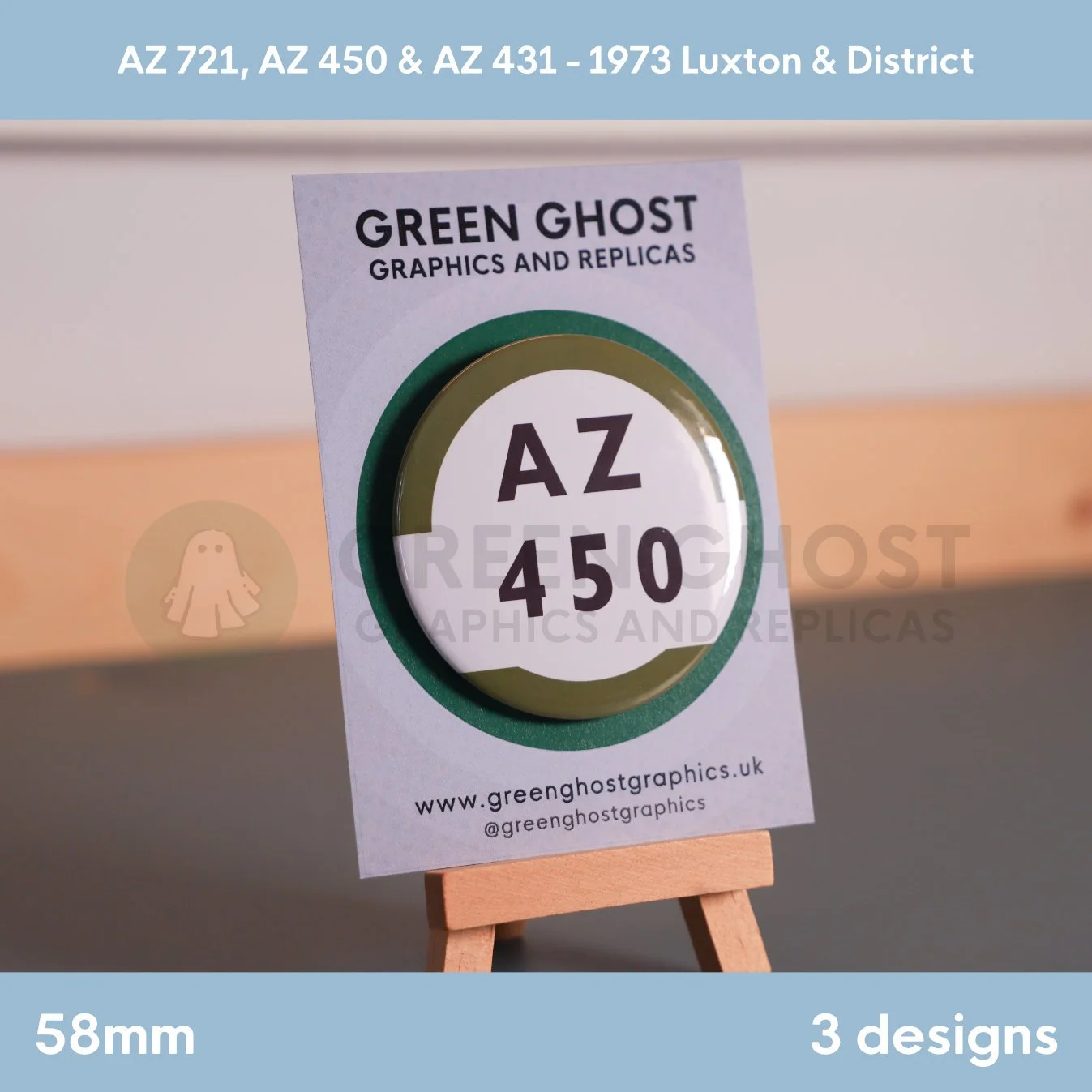 A round white badge with a green border and the text “AZ 450” mounted on a branded backing card on a wooden easel.