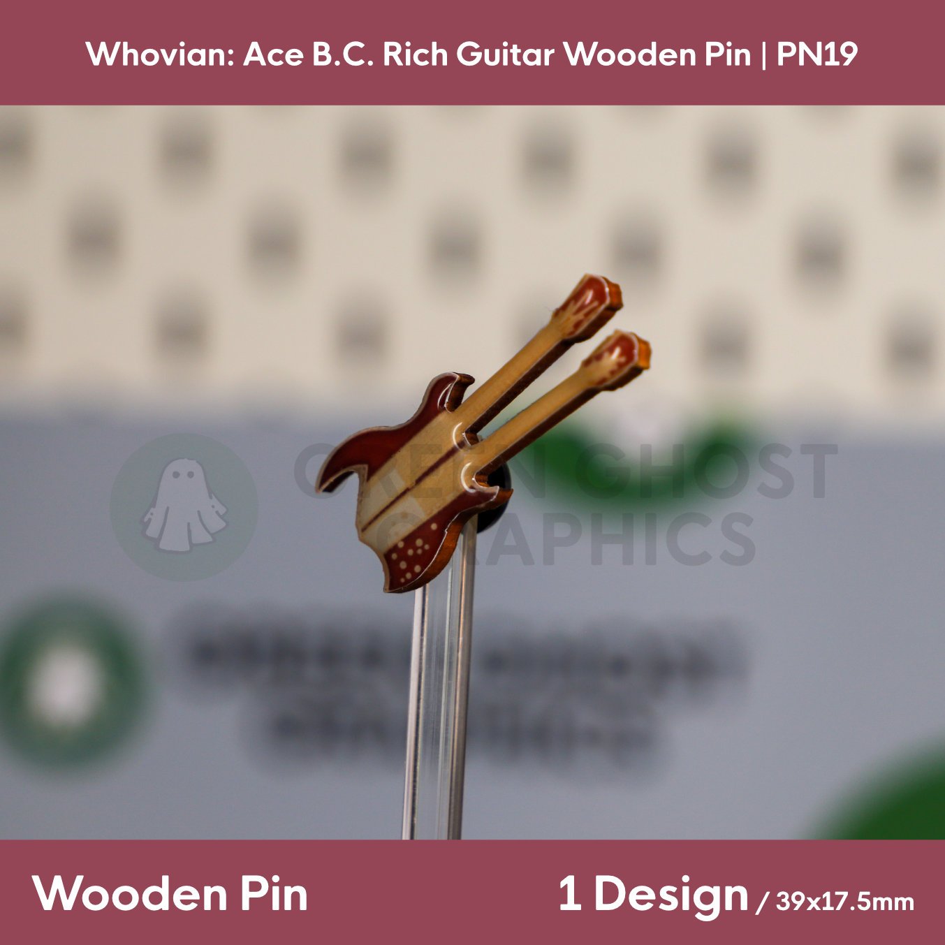 A brown and cream double‑neck guitar wooden pin shown at an angle on a clear stand against a blurred background.