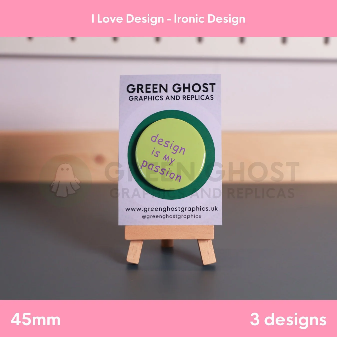 A round green badge with purple “design is my passion” text displayed on a branded card on a wooden easel.