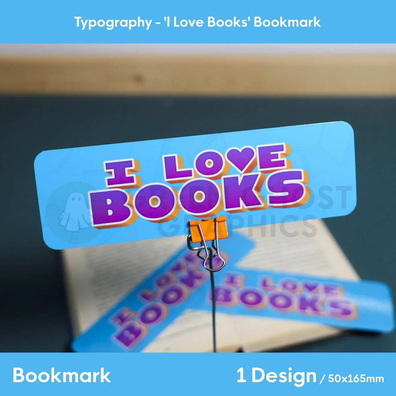 rectangular bookmark with rounded edges. Blue background with pale book symbols across the background. custom purple text reading 'I Love Books', shown against a blurred book background.
