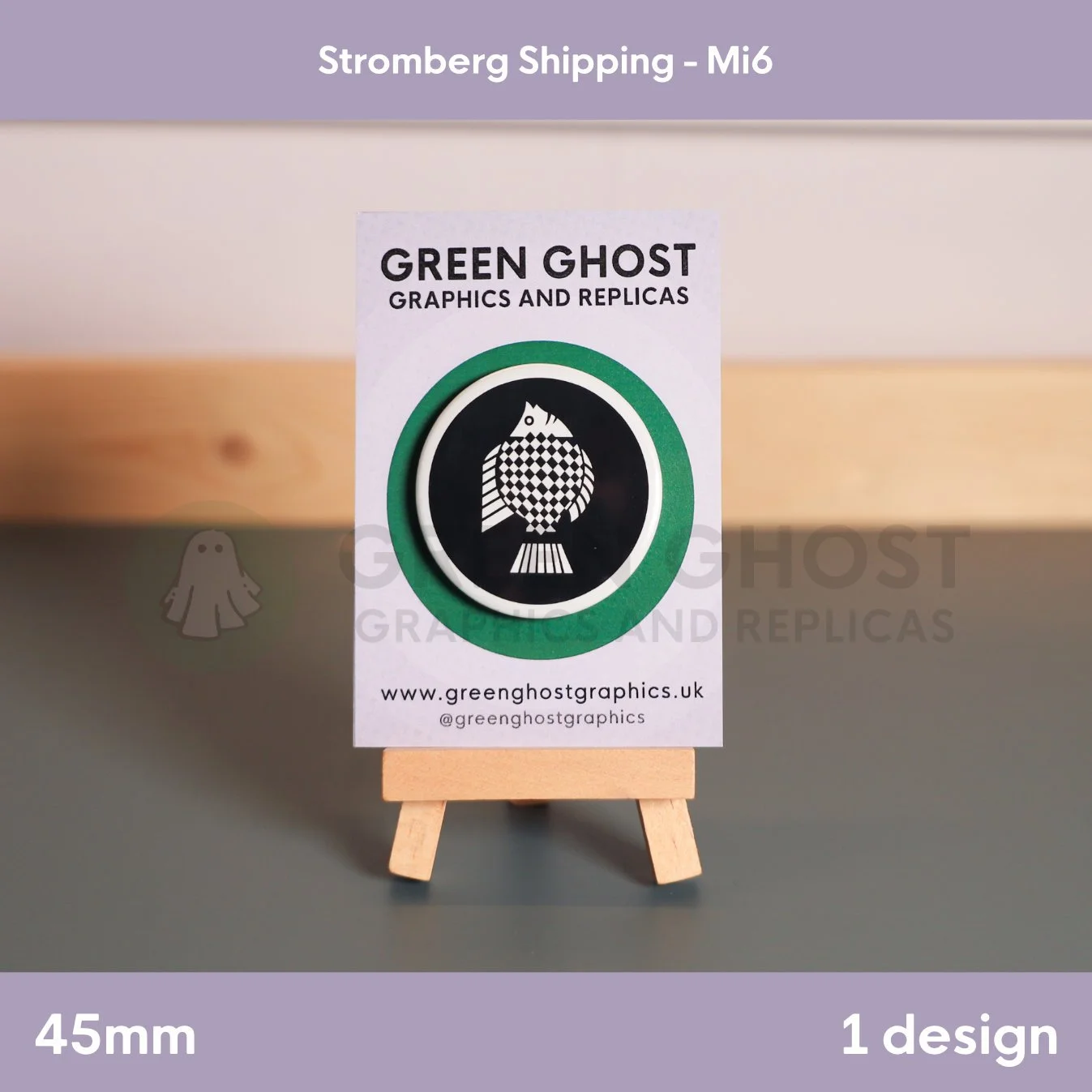 A circular badge with a geometric black‑and‑white fish motif on a wooden easel with a branded card.