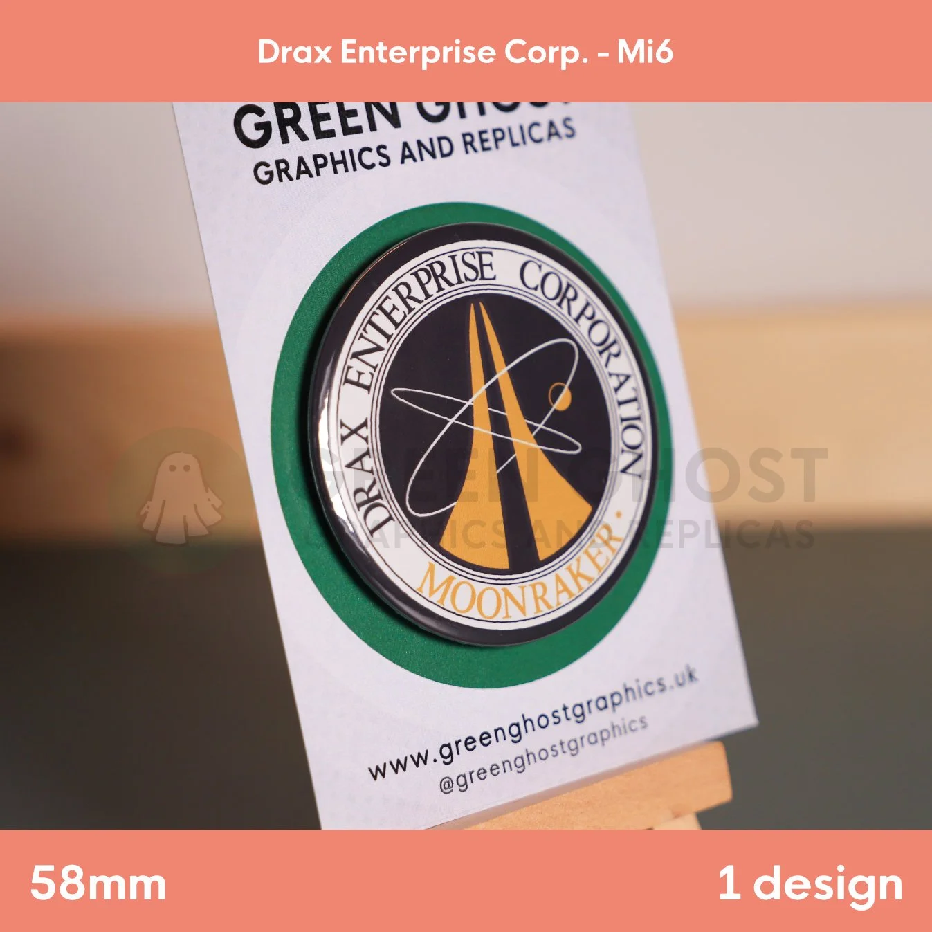 A circular badge with gold rocket imagery and “DRAX ENTERPRISE CORPORATION MOONRAKER” text displayed on a wooden easel with a branded card.