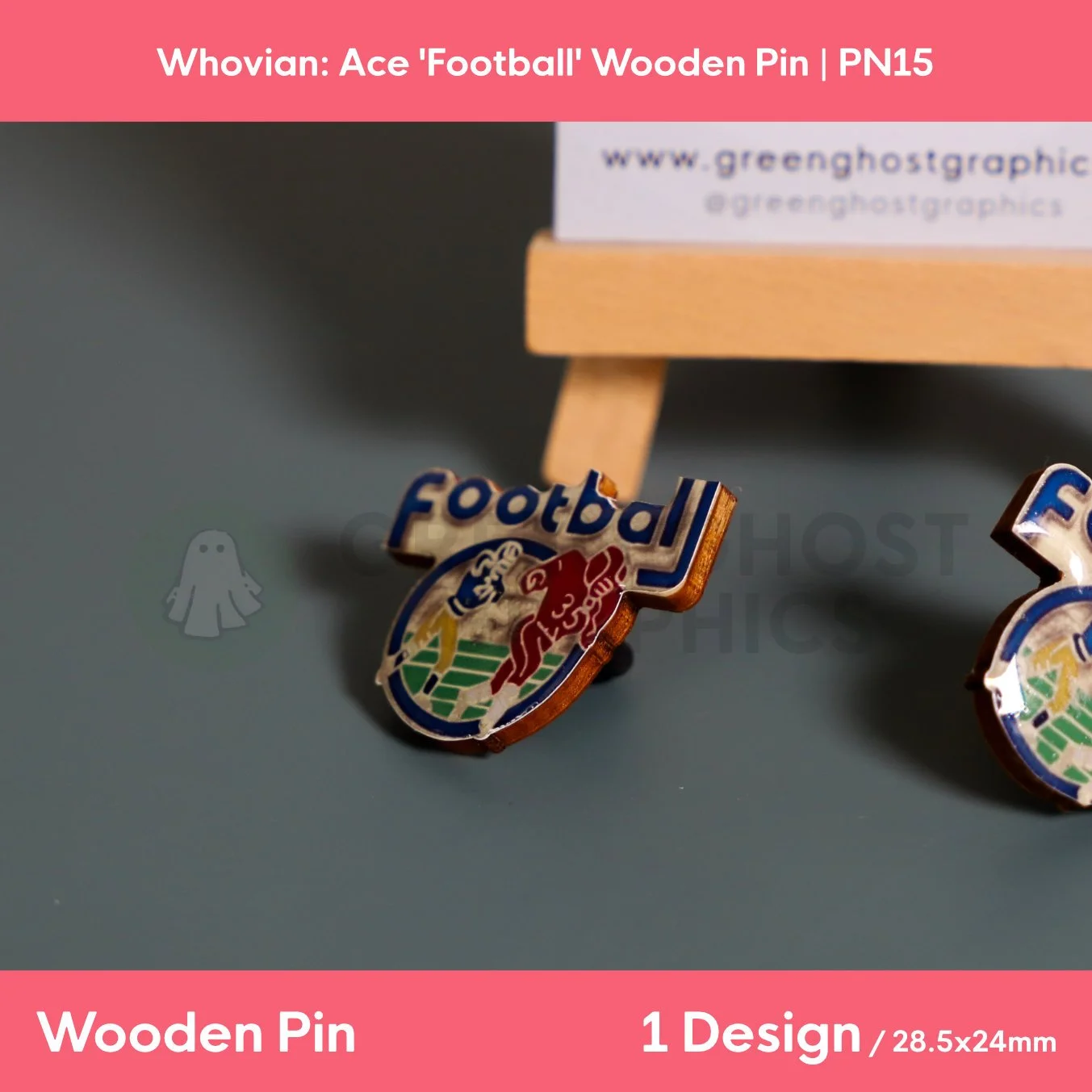A football‑shaped wooden pin with blue “Football” text and a multicoloured player design displayed on a flat surface beside a wooden easel.