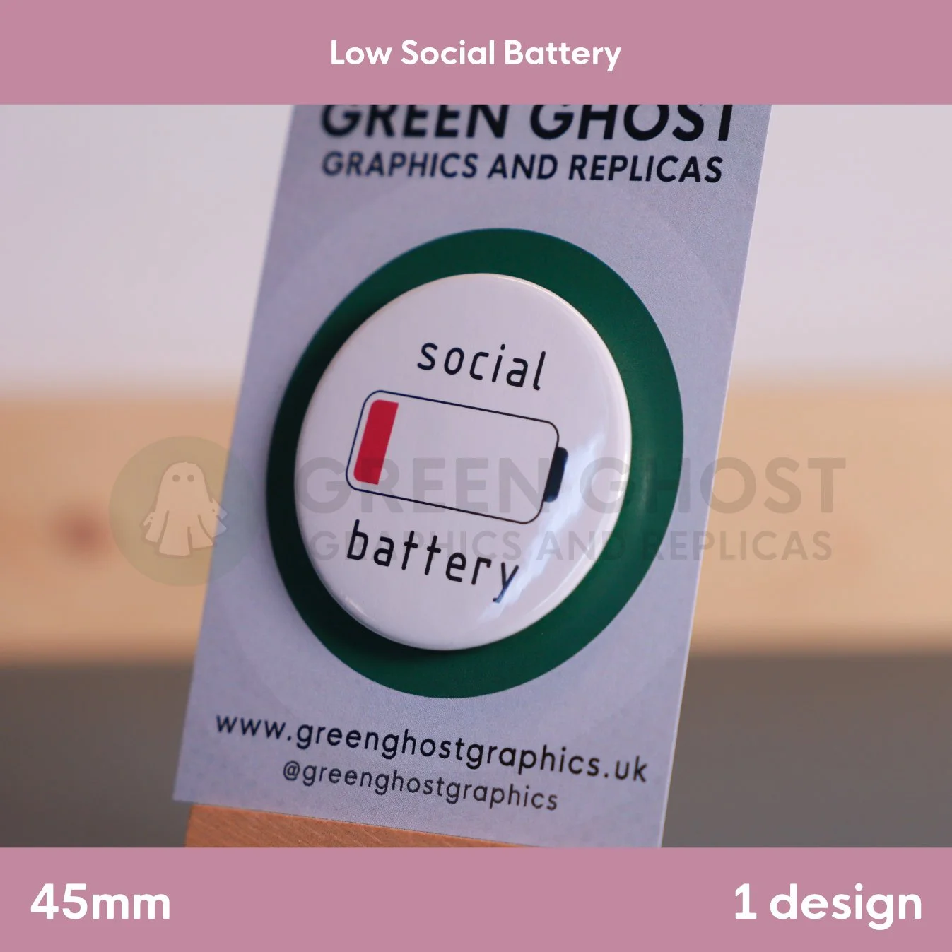A circular white badge with a nearly empty battery icon and “social battery” text attached to a branded display card.