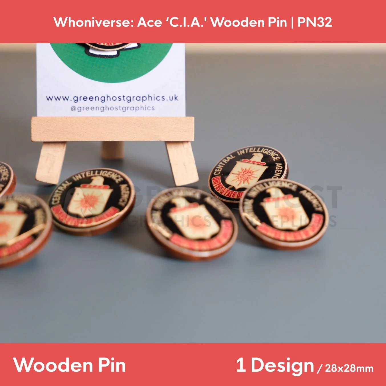 A circular wooden pin featuring coloured text and eagle motif “Central Intelligence Agency, United States of America” with a number of other pins in the background.