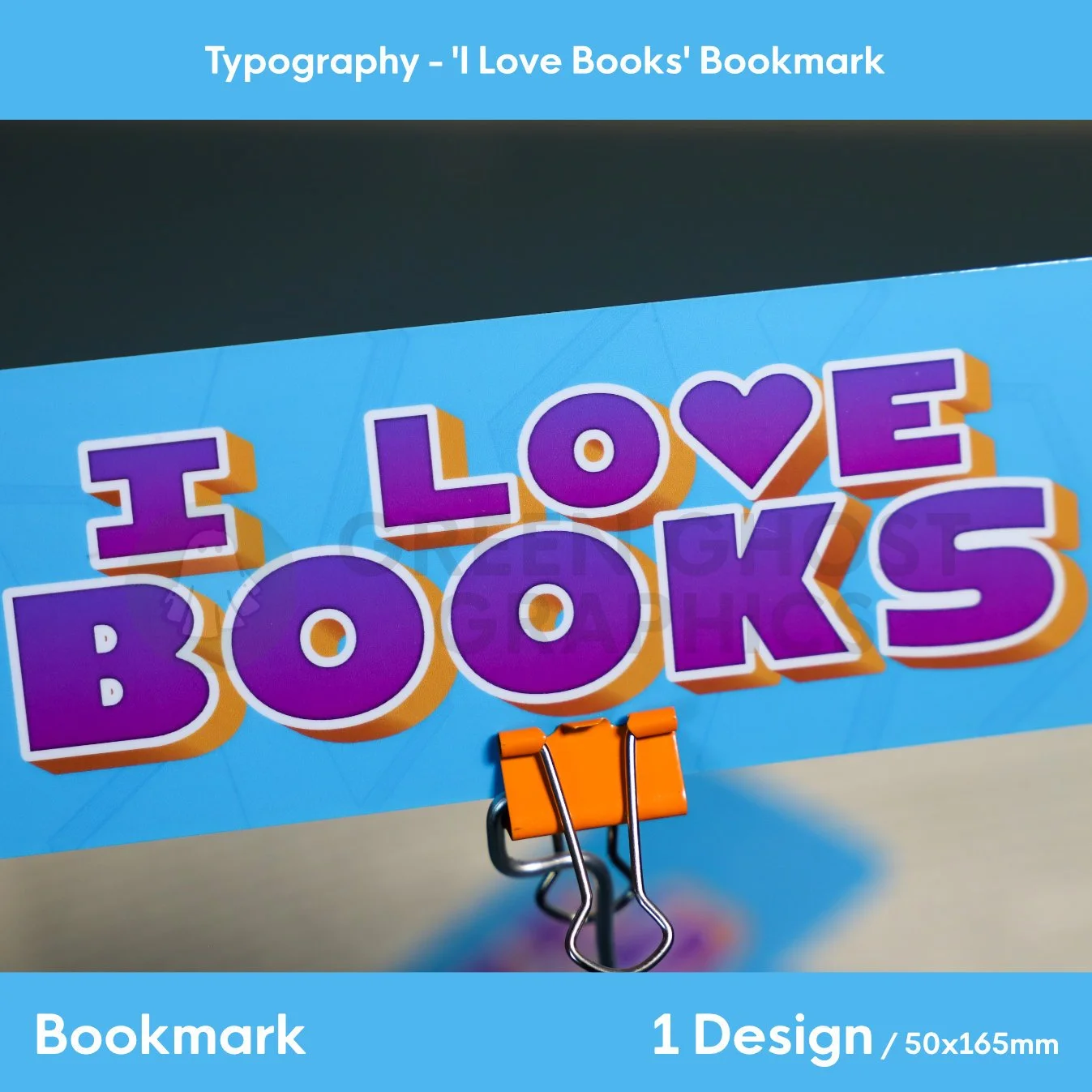 Close up of rectangular bookmark with rounded edges. Blue background with pale book symbols across the background. custom purple text reading 'I Love Books', shown against a blurred book background.