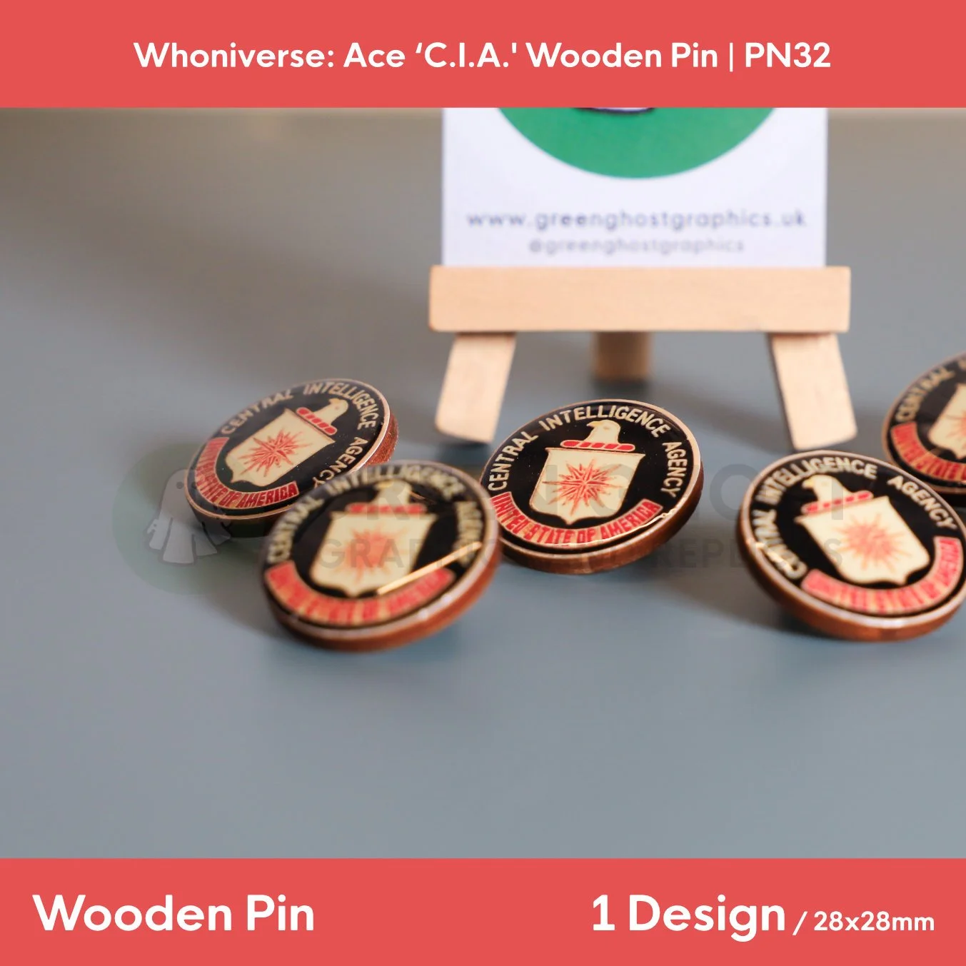 A close up shot of the black circular “Central Intelligence Agency, United States of America” wooden pin with black and red text on a wooden easel.