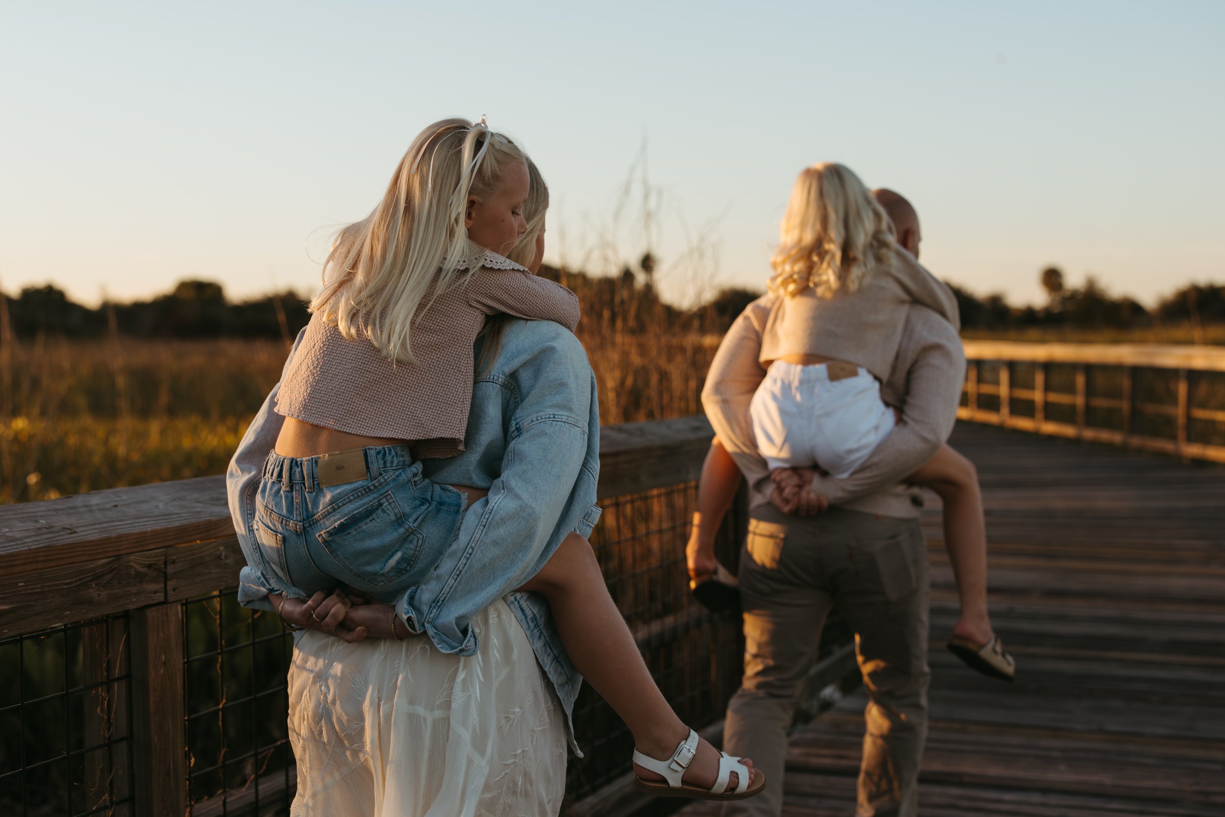 a mother and father holding their daughters in st. cloud florida for a photo lifestyle session