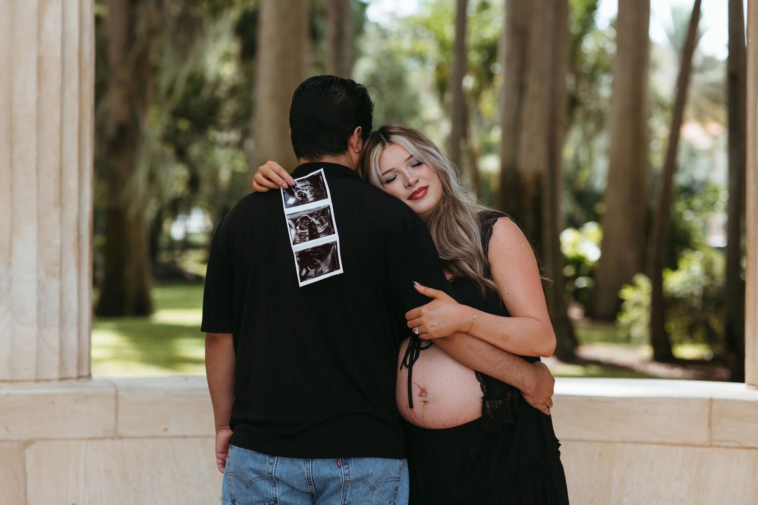 mother and father hold their ultrasound during their maternity session in orlando