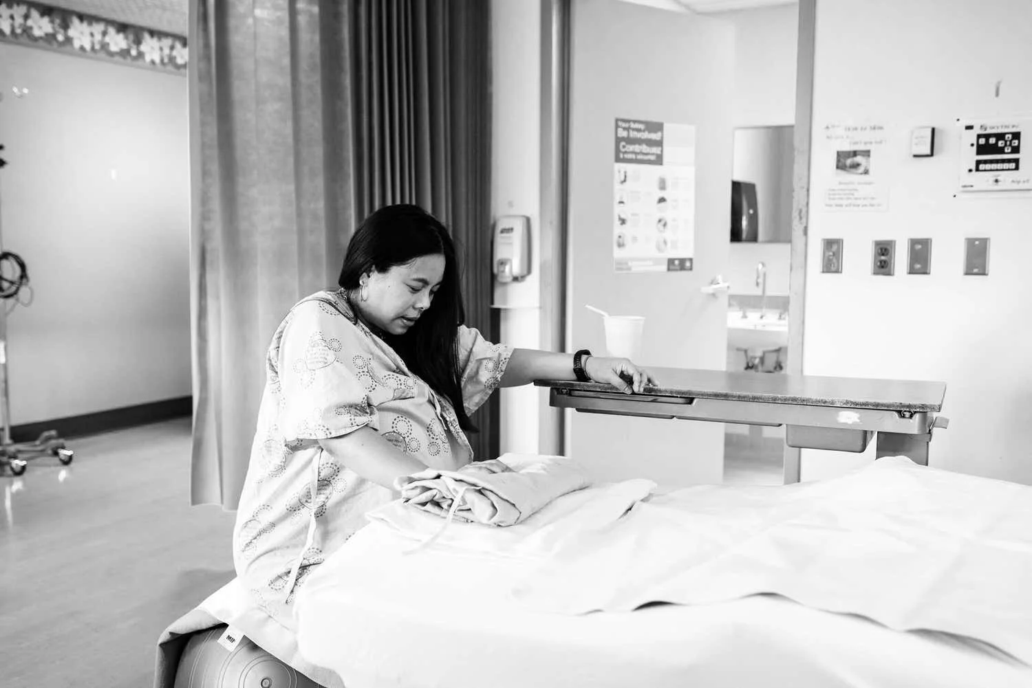 Ottawa mom in labour at hospital looking calm during contraction while sitting on a birthing ball.