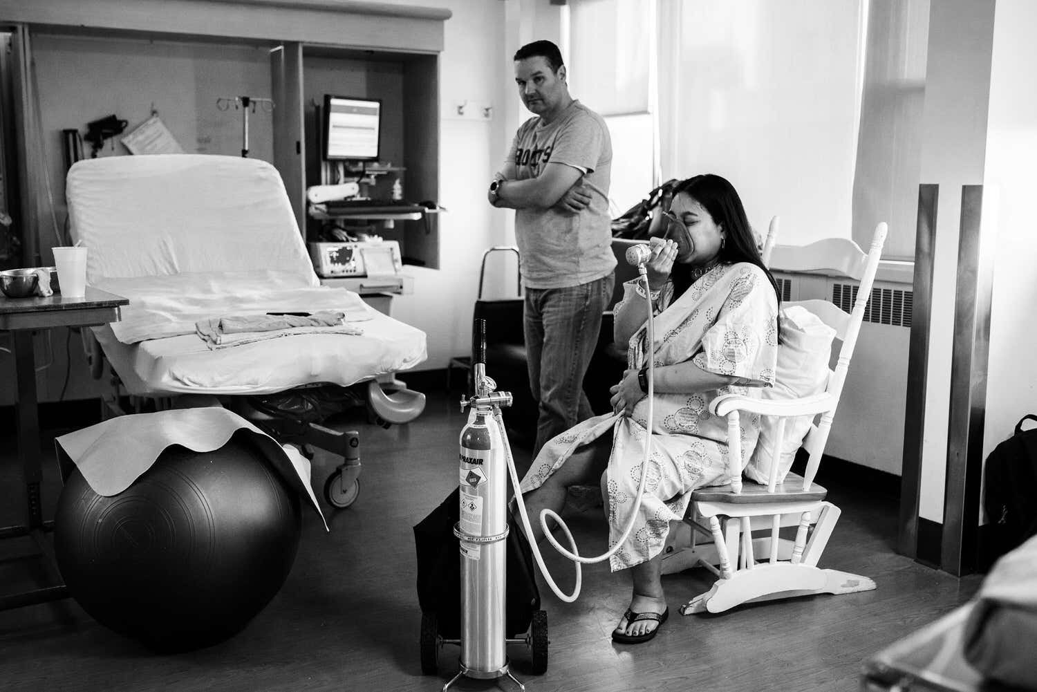 Mom using gas during labour at Ottawa Civic. Dad is beside her and they both look calm and comfortable.