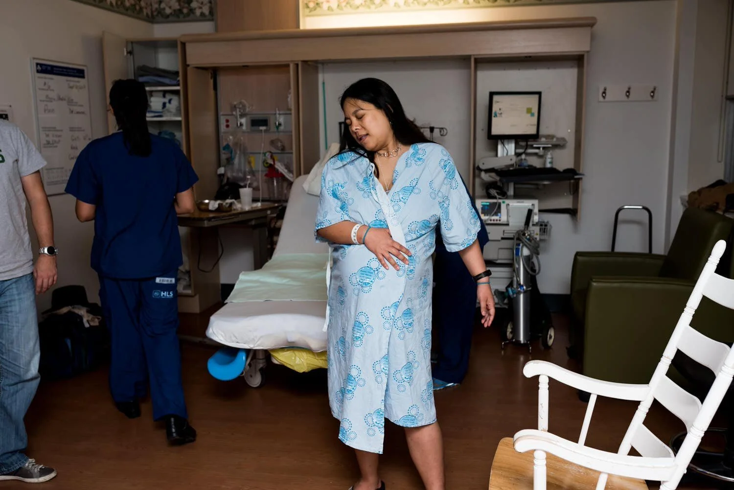 Woman moving through contractions at Ottawa's civic campus hospital. She looks calm.
