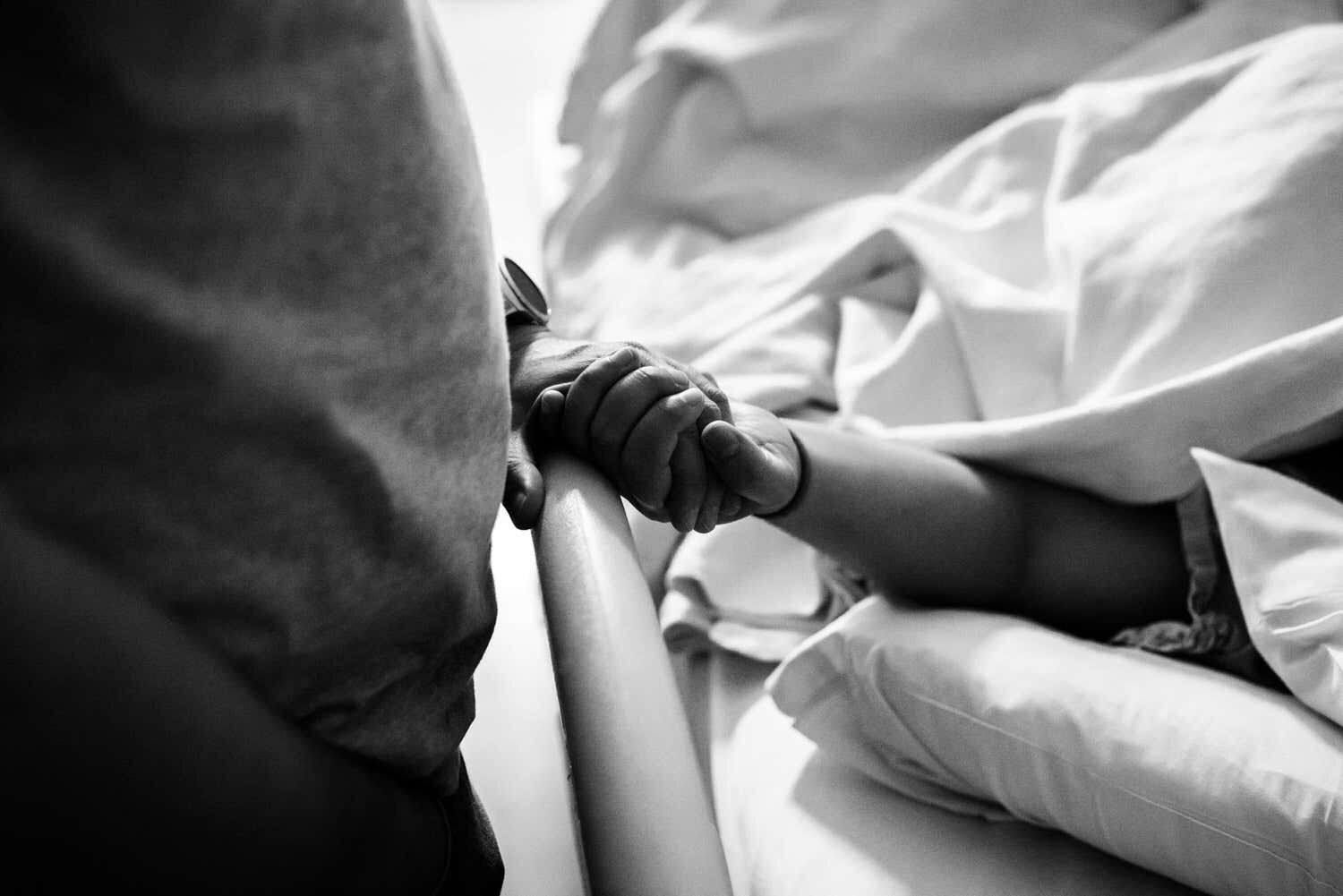 Ottawa parents holding hands while in labour at the civic hospital in ottawa.