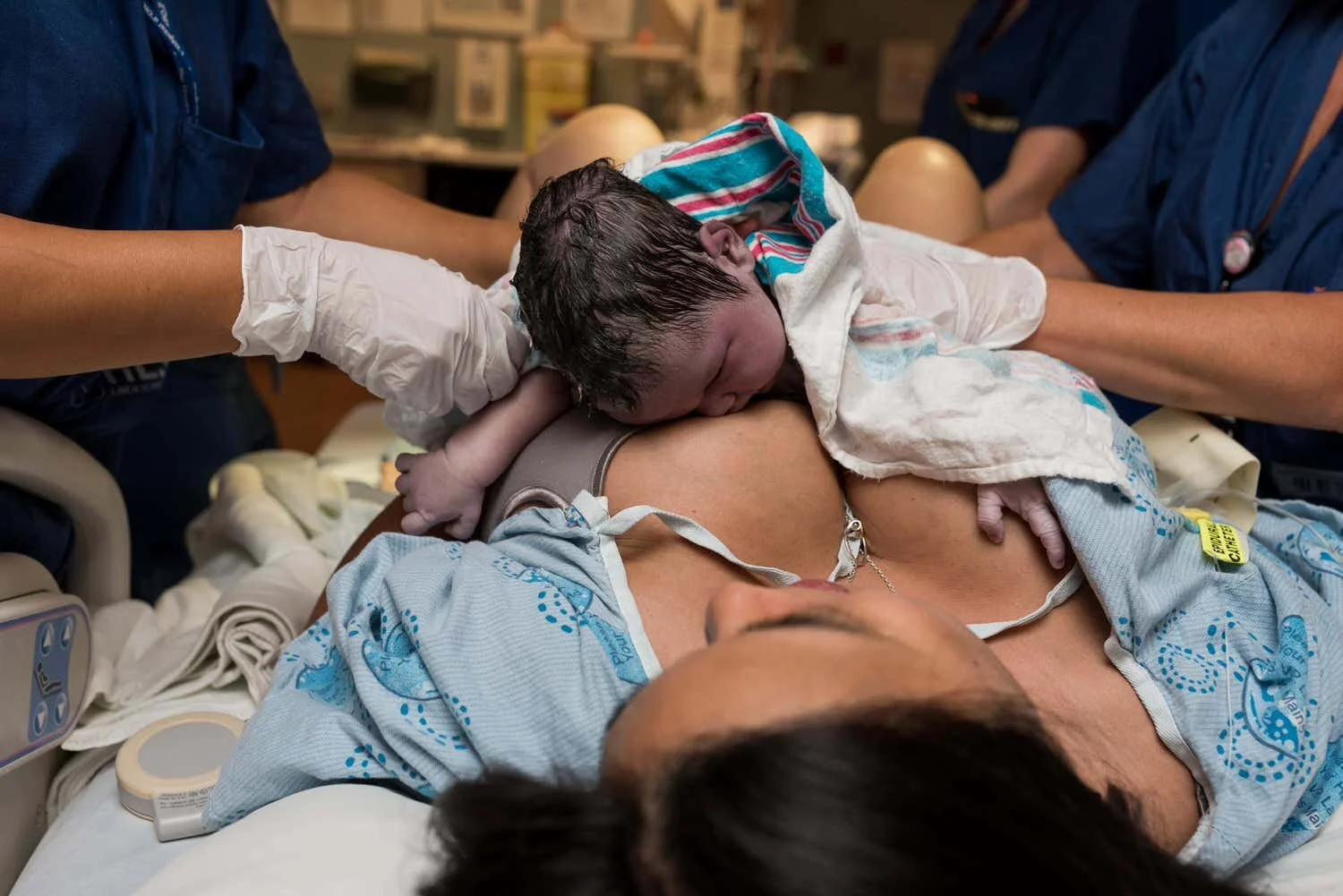 Example of birth photography at civic hospital. Newborn baby boy rests after birth on his mom's chest.