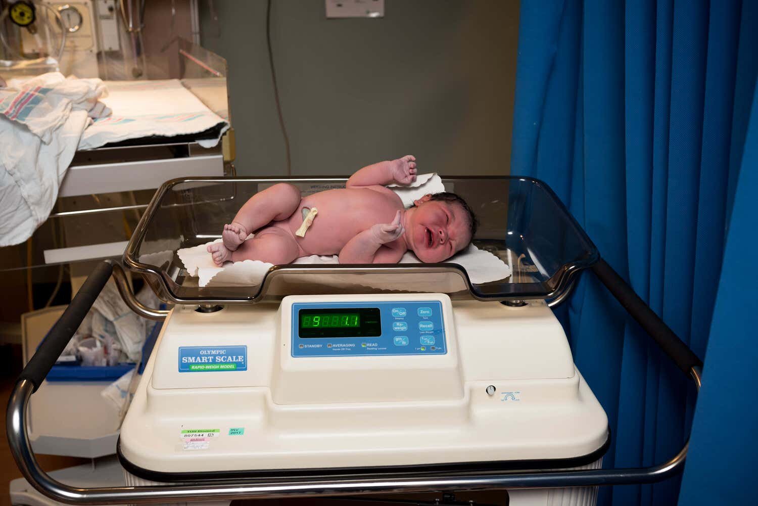 Newborn baby at Civic Hospital in Ottawa being weighed.