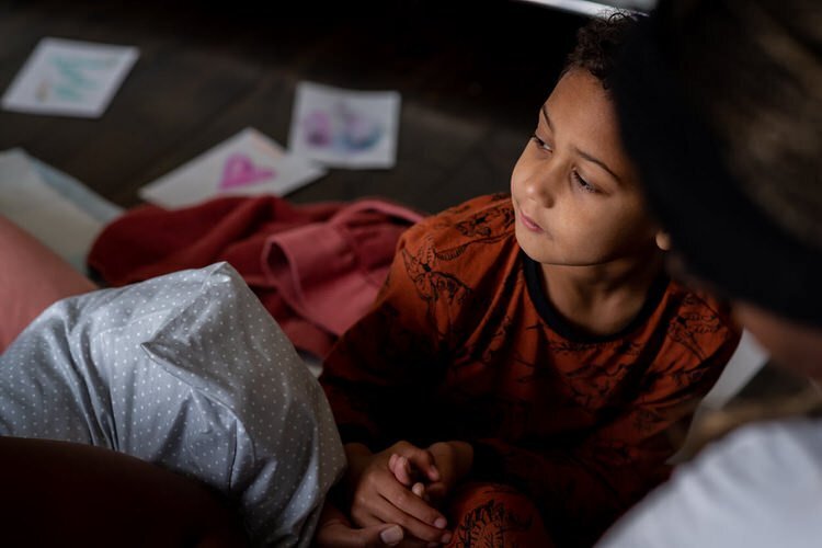 Young boy supporting his mom while she is in labour at home in Ottawa. He is calm and serene and in his pjs.