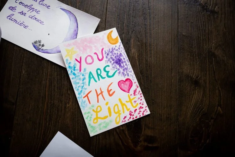 You are the light is painted on a card in many soft colours as a birth affirmation.