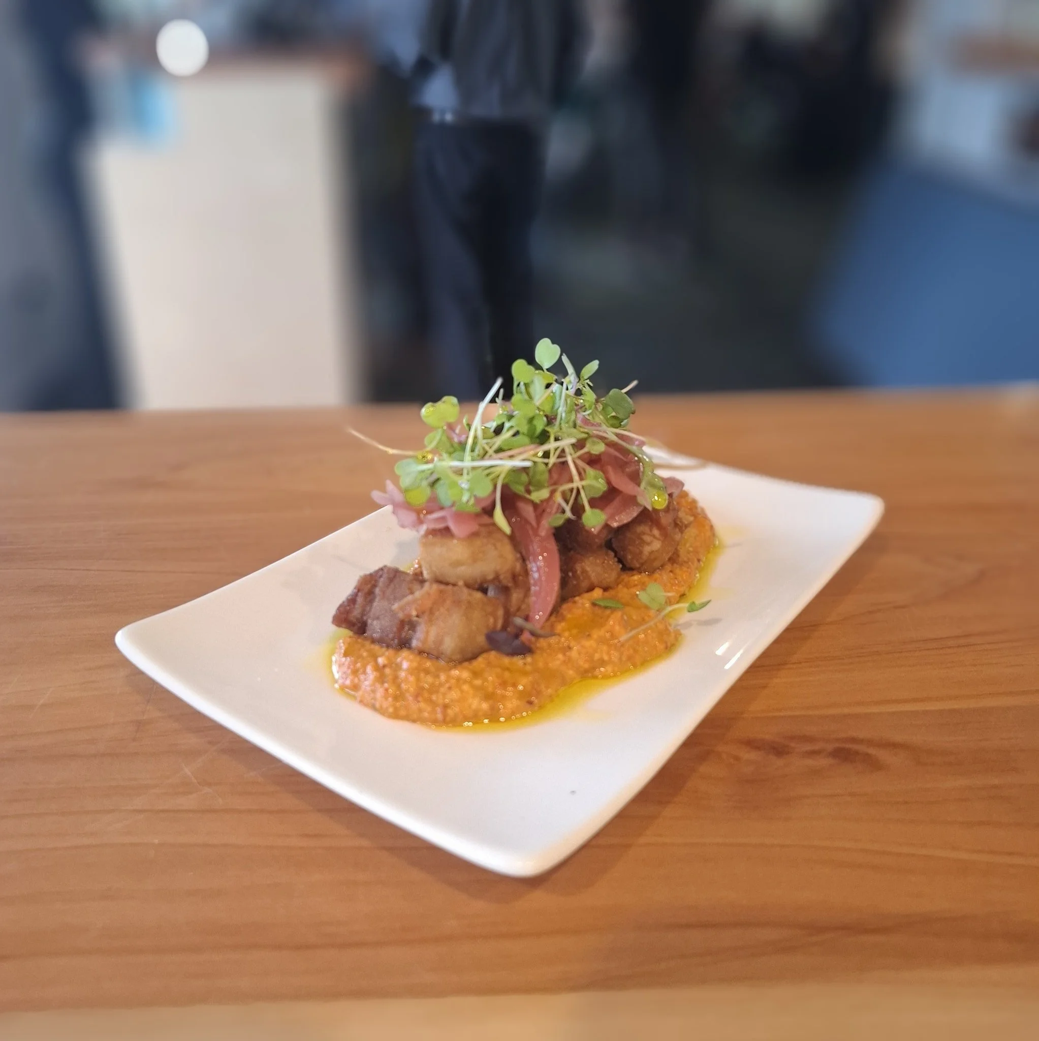 📢New menu items are here!!!📢
Mediterranean Pork Belly one of the delicious new entrées at Riversdale Beach Golf Club 
Crispy pork belly bites, muhummara, pickled red onions, micros and @leafyridgeolives olive oil to finish. 
It's the perf