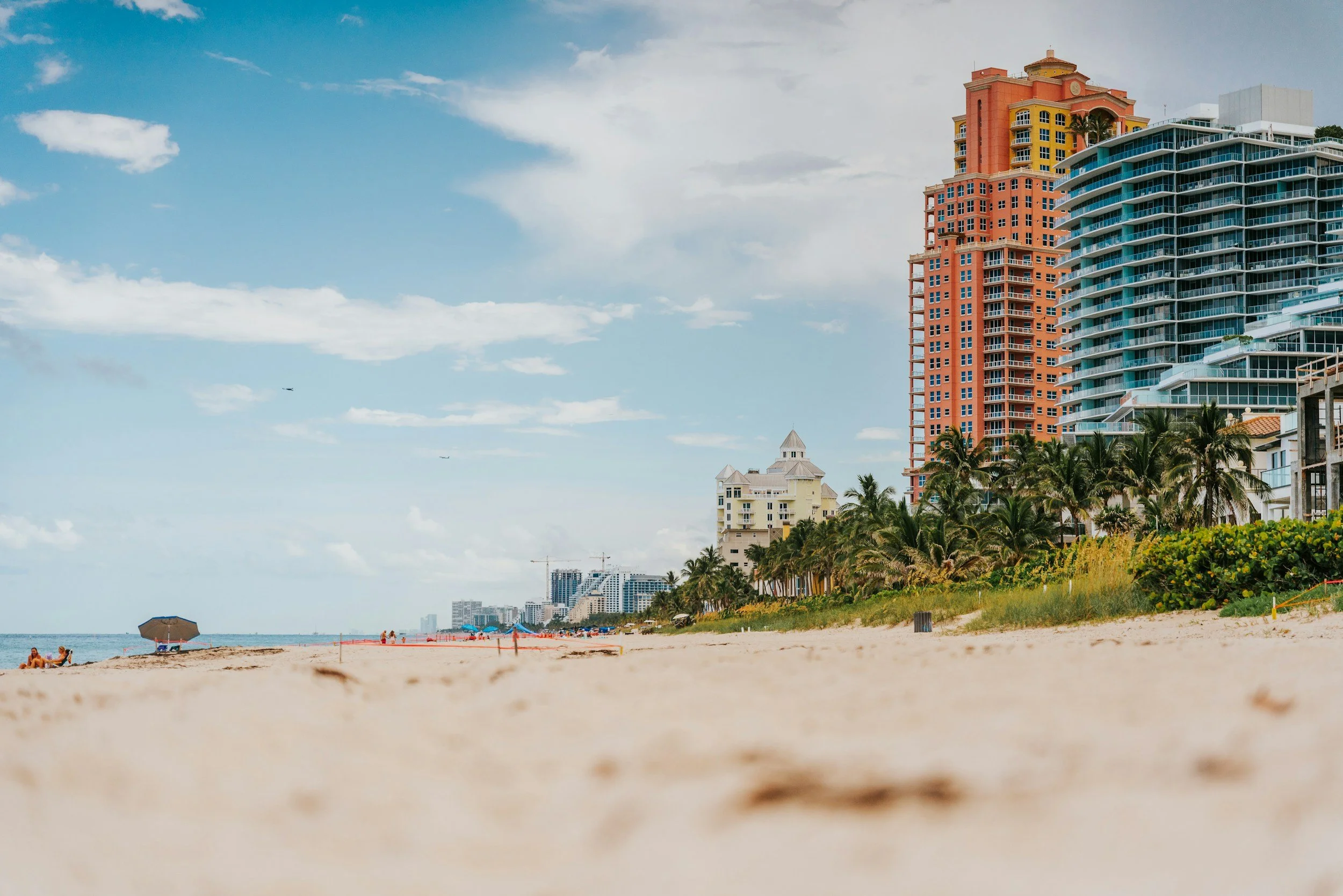 South Florida beach with palm trees and high rise condos along the coast in Fort Lauderdale