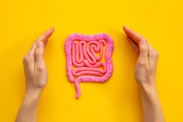 pink bowel with two hands framing it on a yellow background