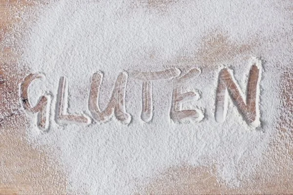 gluten written in flour on a wooden board