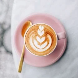 flat white in a pink cup and saucer