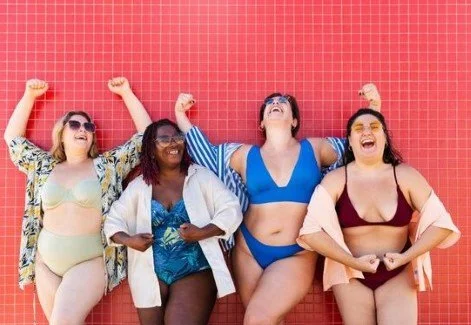 a group of women in swimwear having fun