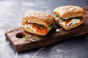 Accept all foods especially bread. Sandwich on a wooden chopping board