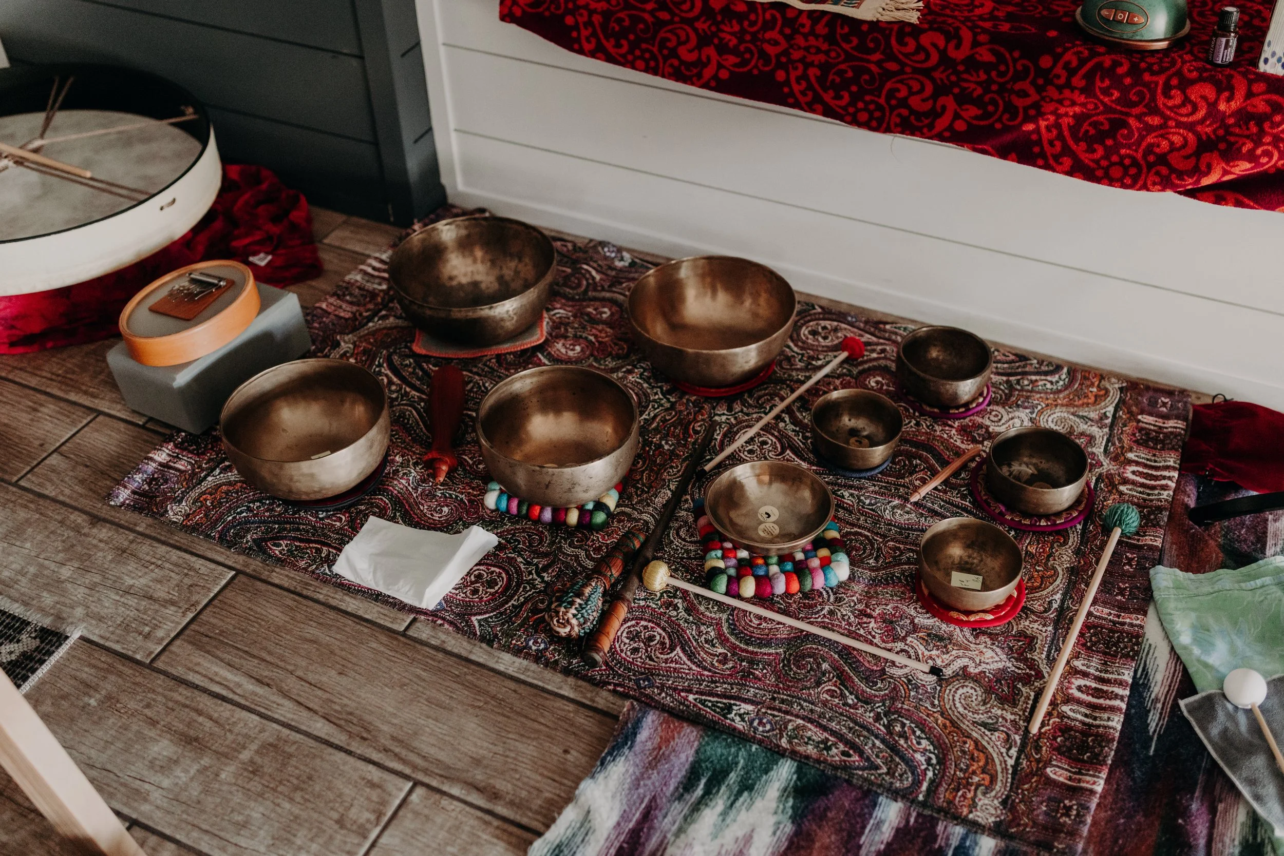 himalayan singing bowls arranged on a tapestry