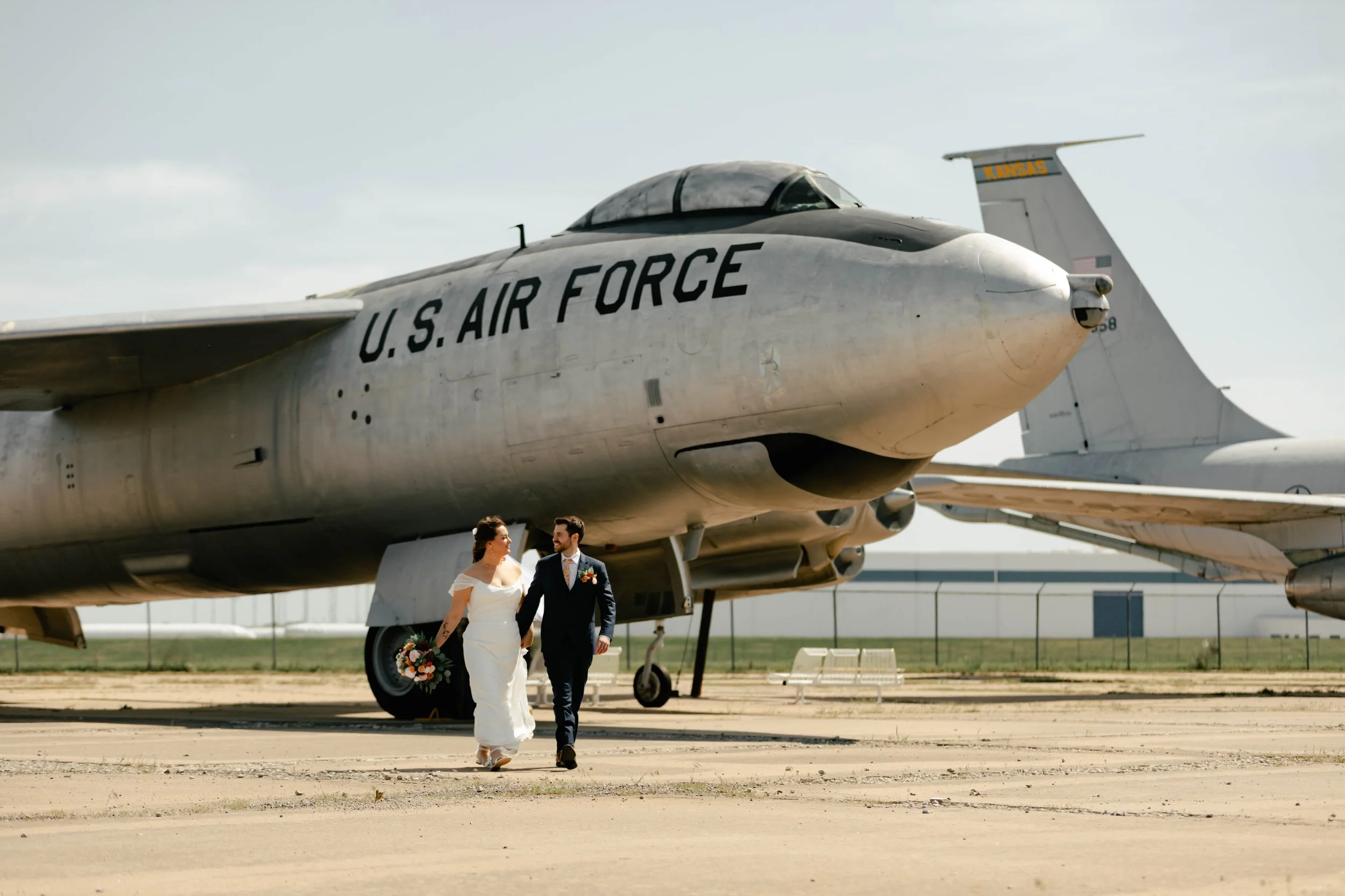 Wichita KS wedding photographer capturing timeless, natural wedding and engagement photos with soft light and true-to-color editing in and around Wichita, Kansas. Venue - Kansas Aviation Museum.