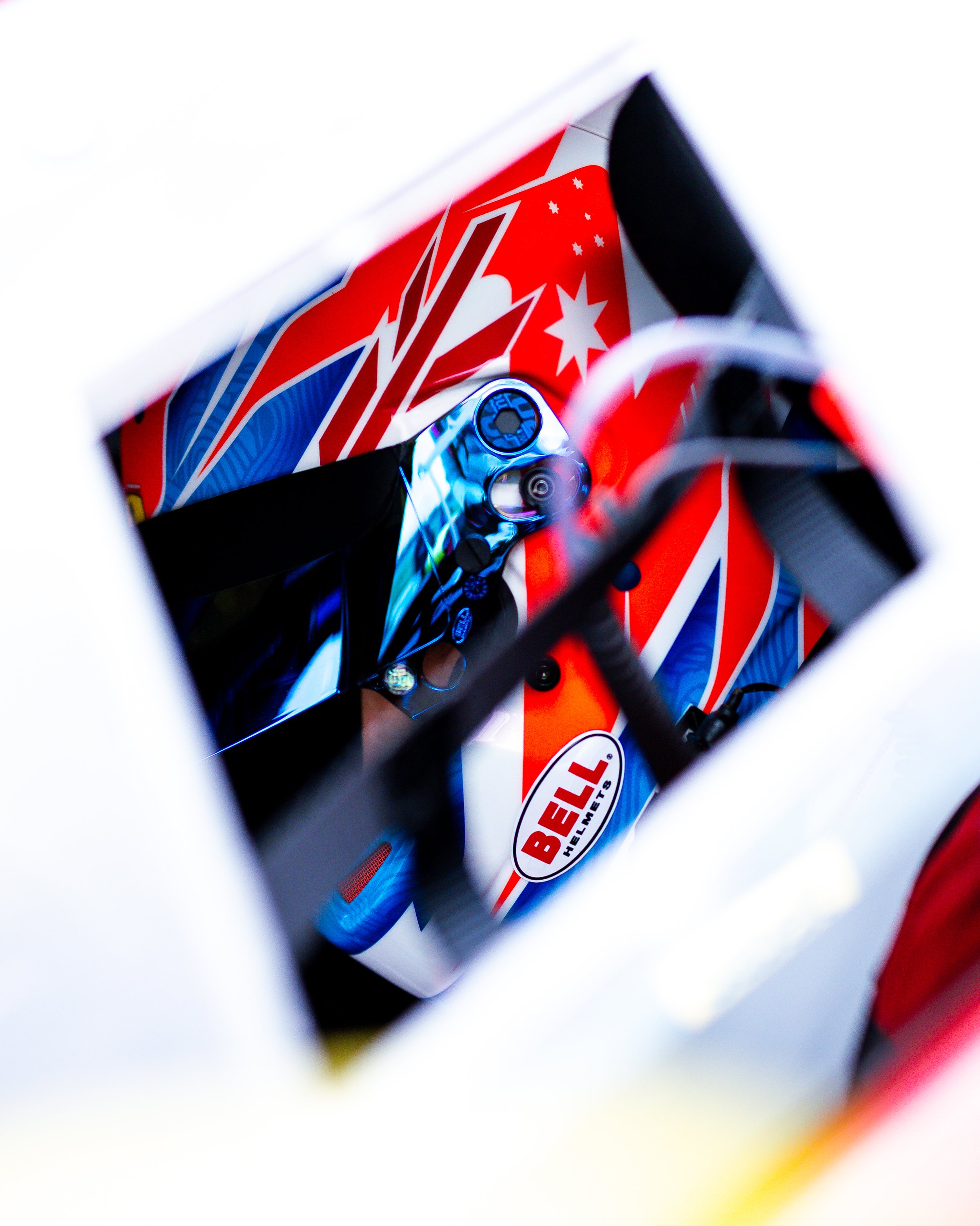 View through a vent into the cockpit of Jordan Love’s Arise Racing GT Ferrari GT World Challenge Australia race car, showing the steering wheel and dashboard.