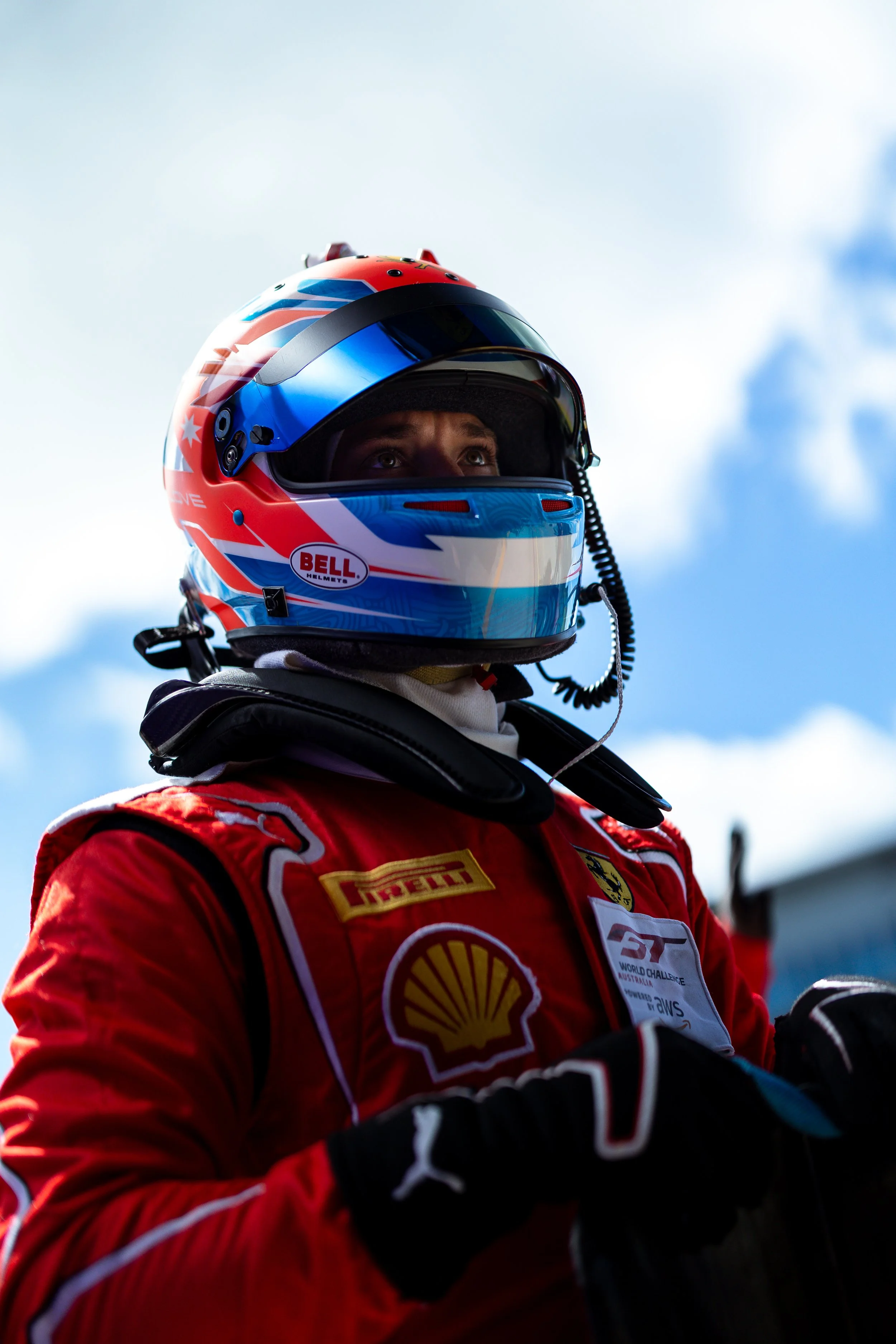 Jordan Love captured from a low angle looking focused as he exits the Arise Racing GT Ferrari 296 race car during the 2025 GT World Challenge.
