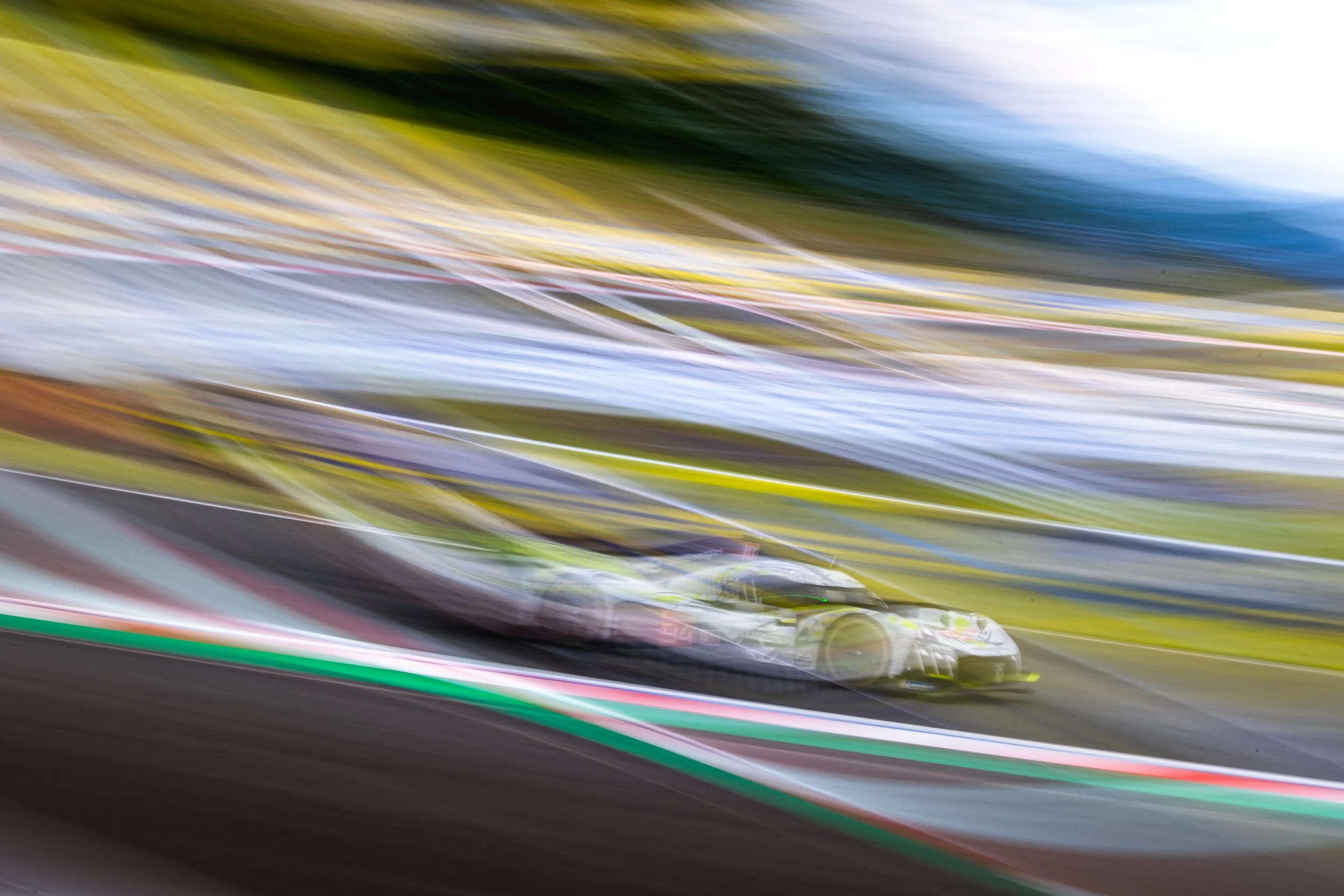 Whip-pan motion blur of the Peugeot Hypercar with light streaks during Practice 1 at the 2024 World Endurance Championship round at Fuji Speedway, Japan.