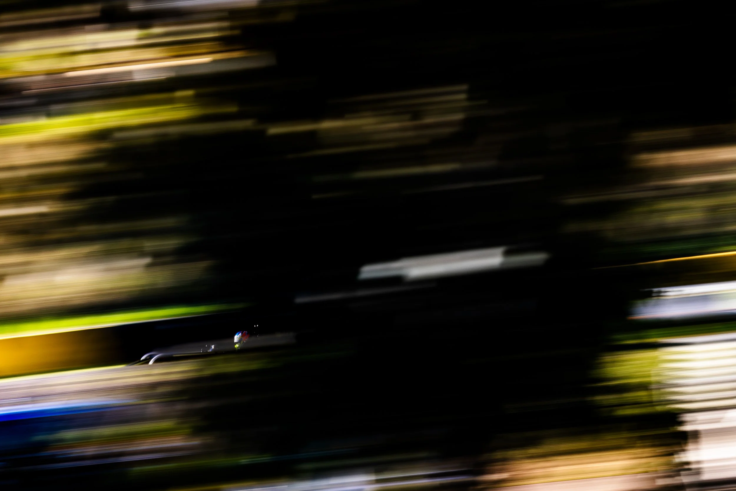 Josh Buchan aboard the Rodin open wheel race car panned through trees at the 2024 World Time Attach Challenge. 