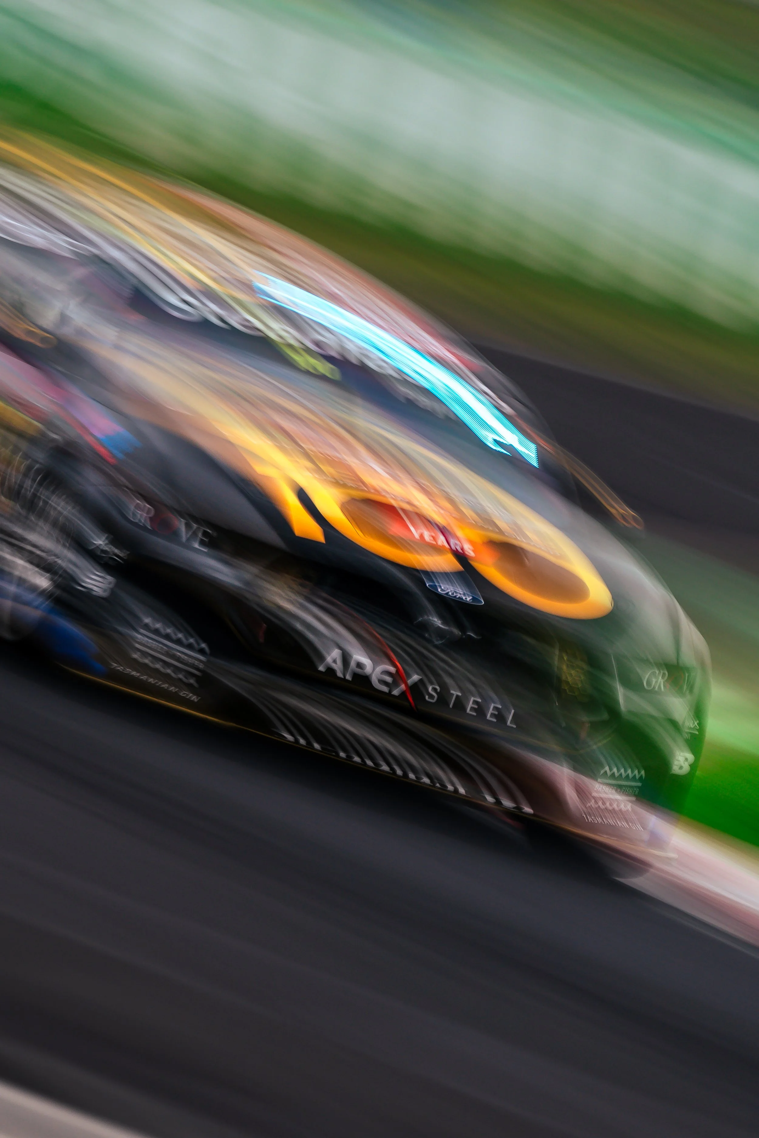 Grove Racings Ford Mustang Supercar exiting Turn 1 captured by a whip-pan at the 2025 Bathurst 1000.