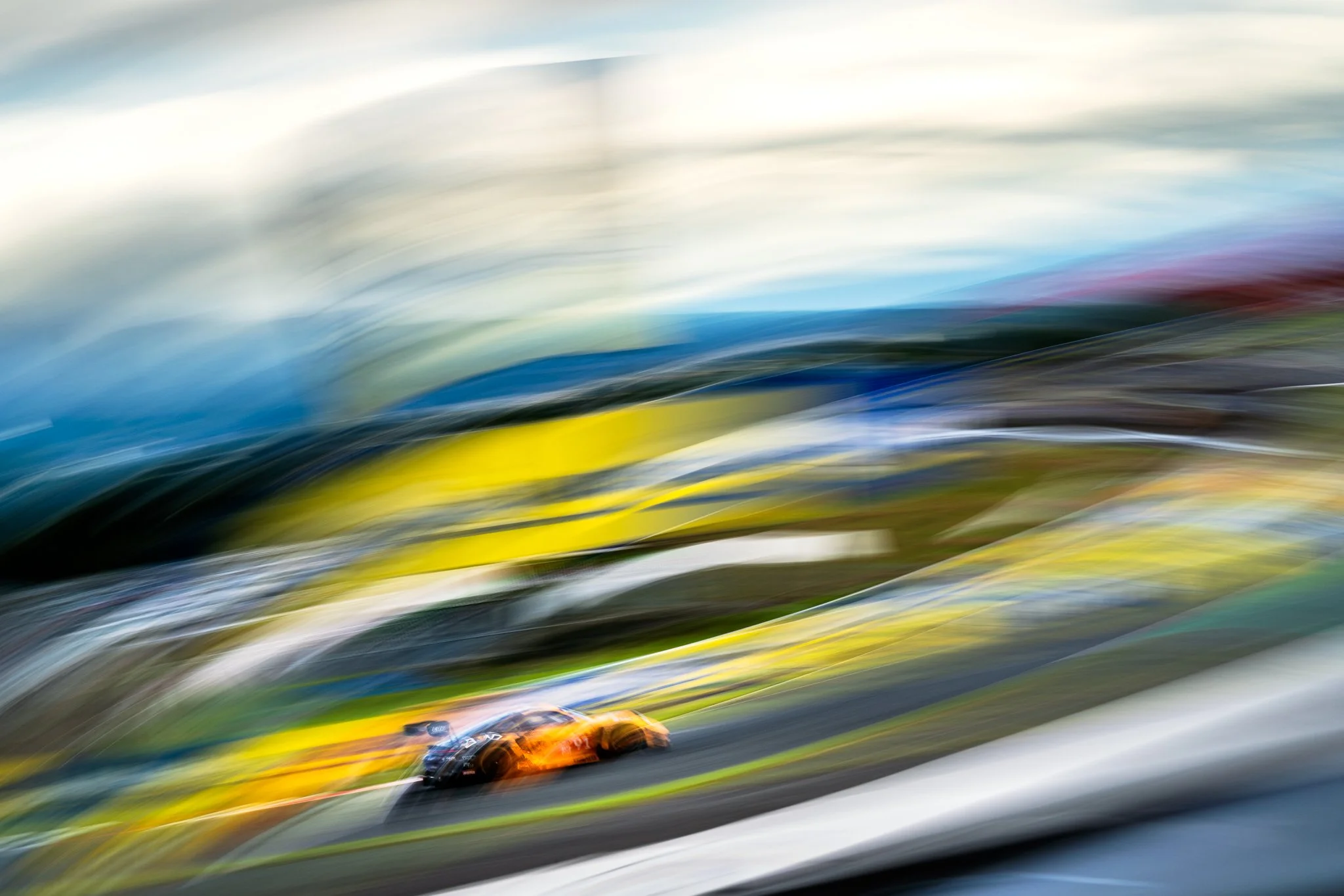 Whip-pan motion blur resembling an oil painting of the Porsche 911 GT3 R sponsored by The Bend Motorsport Park at the 2025 World Endurance Championship round at Fuji Speedway.