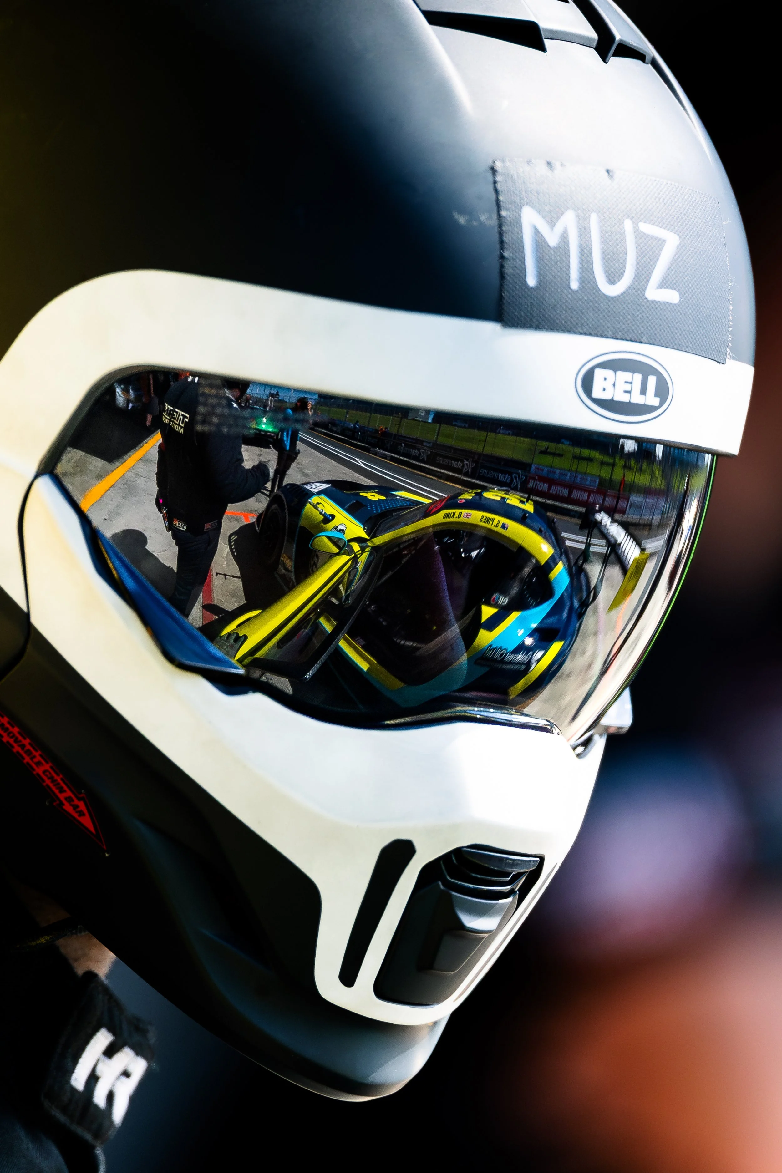 Close-up of a Tigani Motorsport mechanic with the Mercedes-AMG GT3 reflected in the visor at the 2025 GT World Challenge Australia round at Hampton Downs.