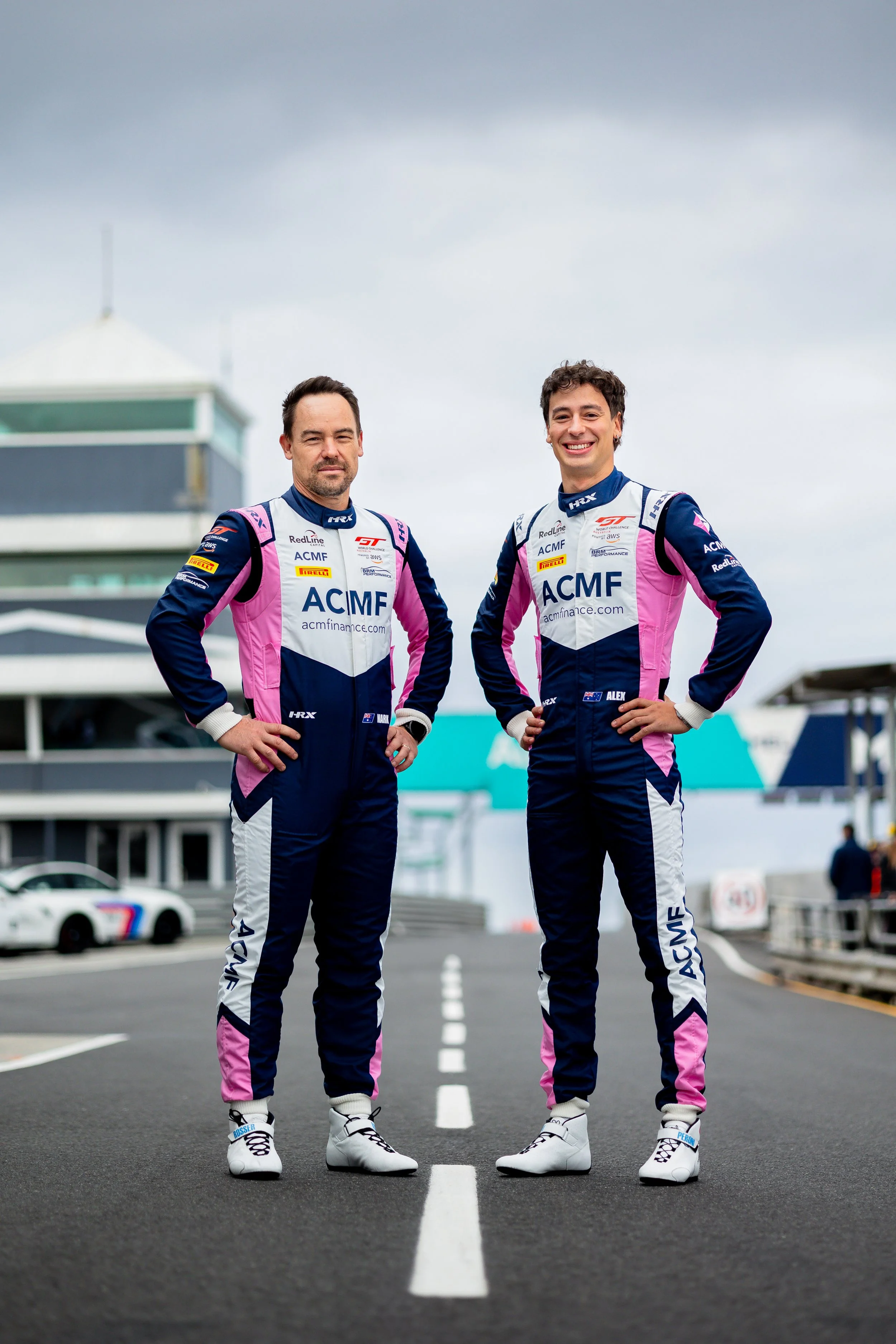 Mark Rosser and Alex Peroni pose for a team photo at the 2025 GT World Challenge Australia round at Phillip Island.