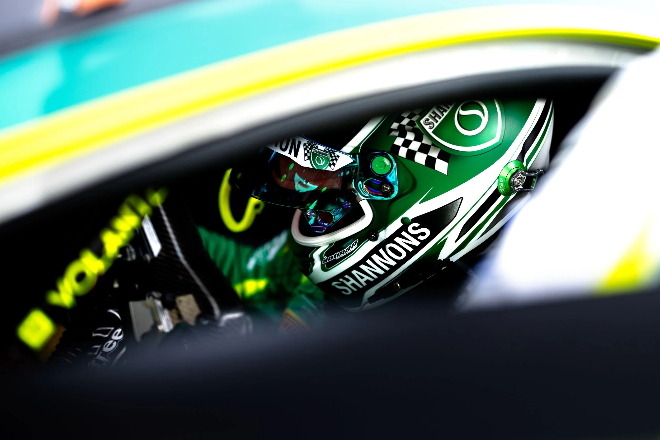 Liam Talbot strapping into the Volante Rosso Aston Martin GT3 race car during the 2025 GT World Challenge season. 